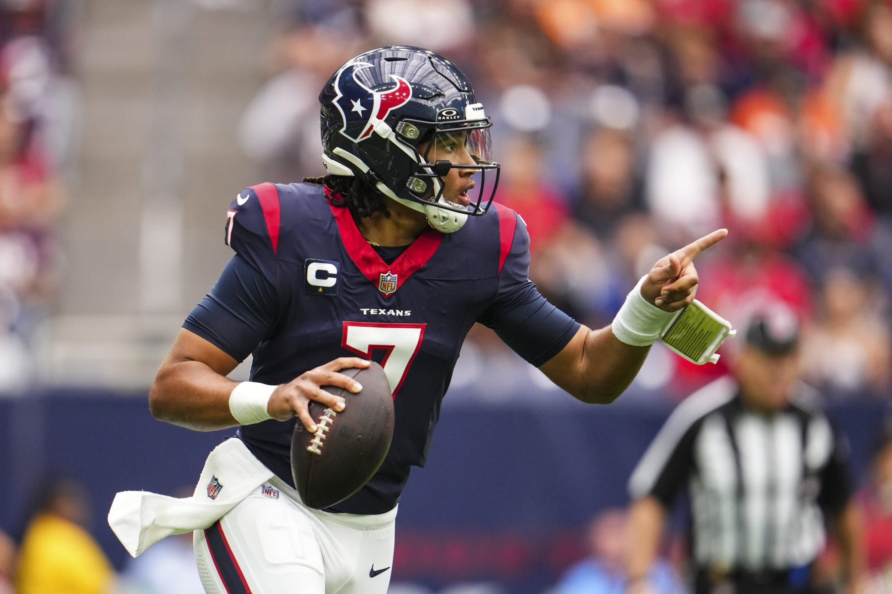HOUSTON, TX - NOVEMBER 05: C.J. Stroud #7 of the Houston Texans scrambles out of the pocket during an NFL football game against the Tampa Bay Buccaneers at NRG Stadium on November 5, 2023 in Houston, Texas. (Photo by Cooper Neill/Getty Images)
