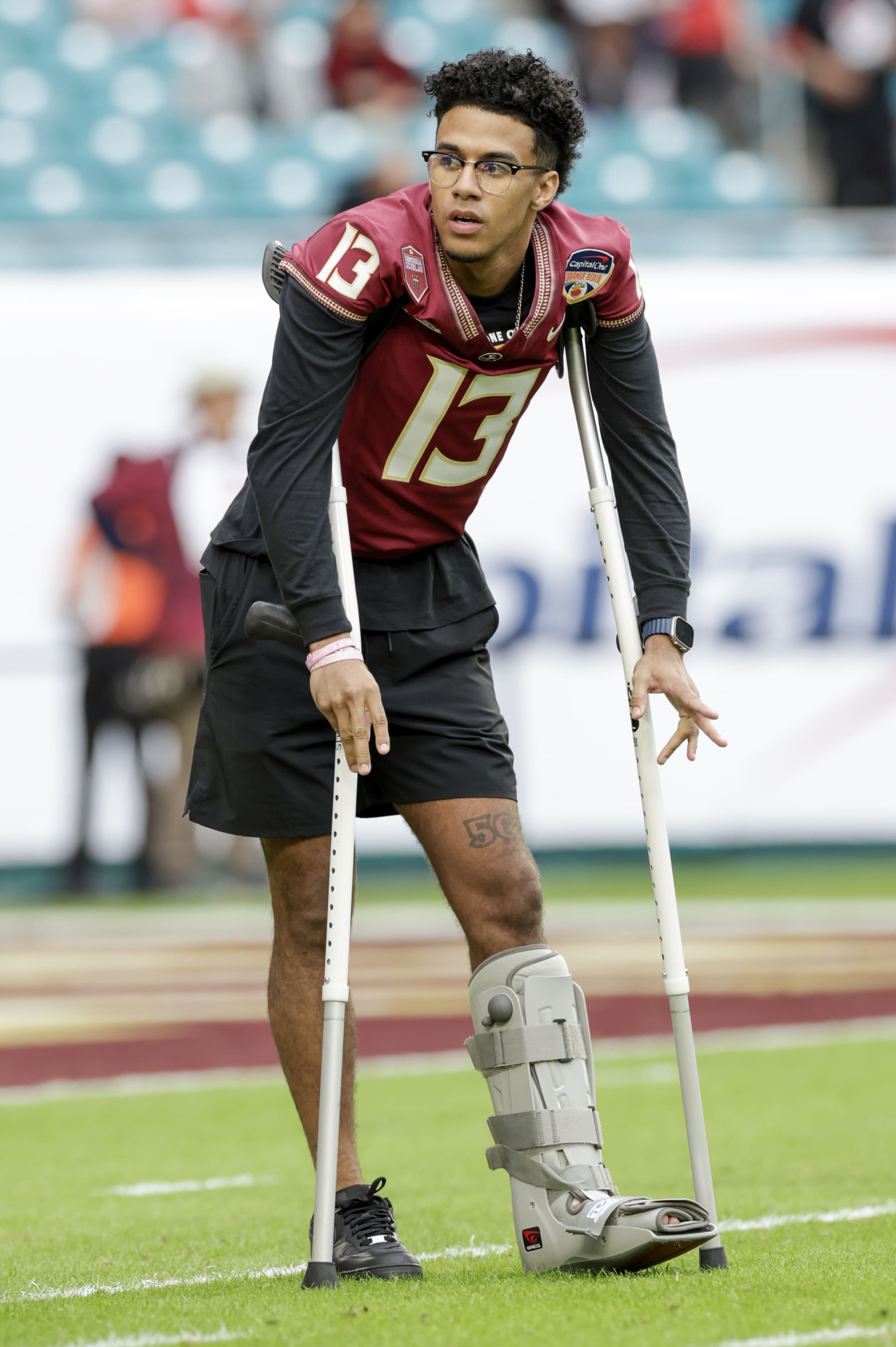 MIAMI GARDENS, FL - DECEMBER 30: Florida State Seminoles quarterback Jordan Travis (13) looks on before the game between the Georgia Bulldogs and the Florida State Seminoles on December 30, 2023 at Hard Rock Stadium in Miami Gardens, Fl.  (Photo by David Rosenblum/Icon Sportswire via Getty Images)
