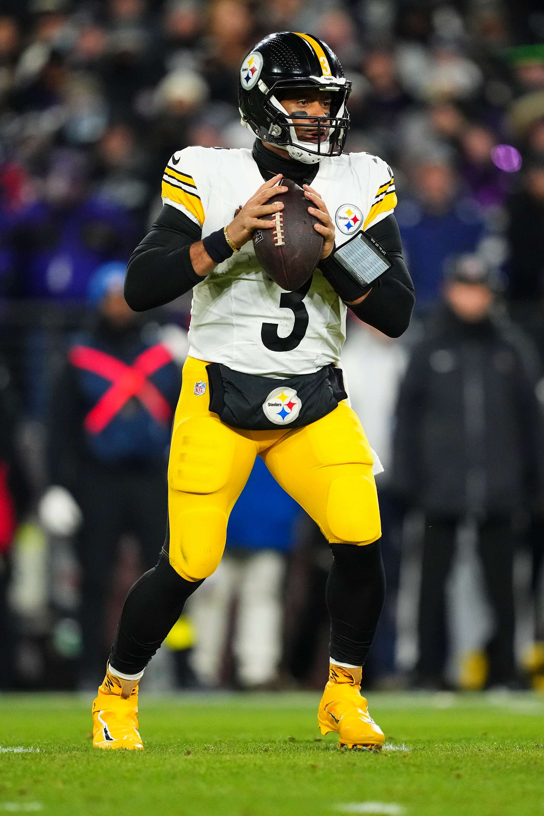 BALTIMORE, MD - JANUARY 11: Russell Wilson #3 of the Pittsburgh Steelers drops back to pass during an NFL football wild card playoff game against the Baltimore Ravens at M&T Bank Stadium on January 11, 2025 in Baltimore, Maryland. (Photo by Cooper Neill/Getty Images)