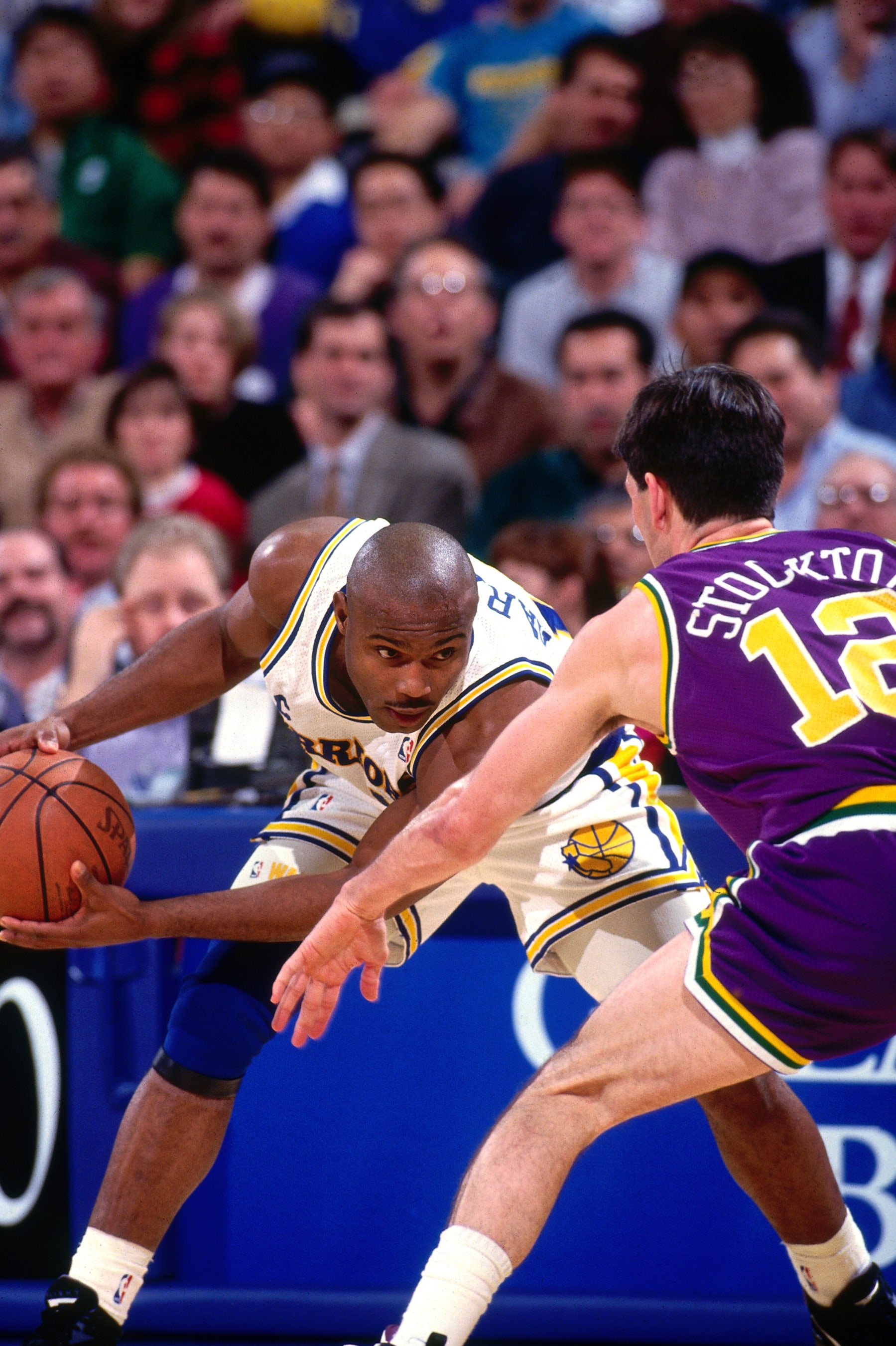 OAKLAND, CA - 1993: Tim Hardaway of the Golden State Warriors handles the ball defended by John Stockton of the against the Utah Jazz during a game in 1993 at The Oakland-Alameda County Coliseum Arena in Oakland, California.  NOTE TO USER: User expressly acknowledges and agrees that, by downloading and/or using this Photograph, user is consenting to the terms and conditions of the Getty Images License Agreement. Mandatory Copyright Notice: Copyright 1993 NBAE (Photo by Sam Forencich/NBAE via Getty Images)