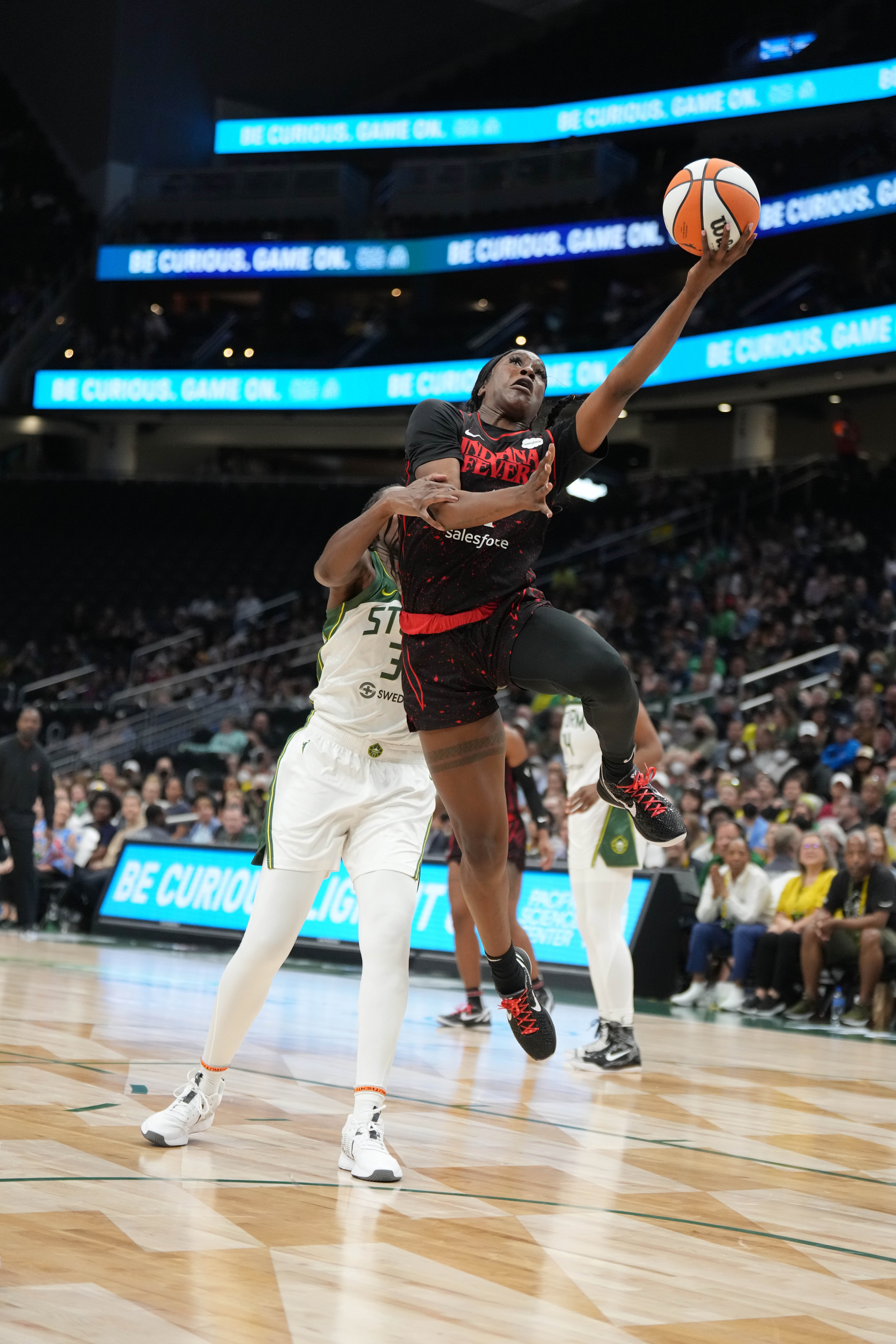 Seattle, WA - MAY 1: Queen Egbo #4 of the Indiana Fever drives to the basket during the game against the Seattle Storm on May 1, 2022 at Climate Pledge Arena in Seattle, WA. NOTE TO USER: User expressly acknowledges and agrees that, by downloading and or using this Photograph, user is consenting to the terms and conditions of the Getty Images License Agreement. Mandatory Copyright Notice: Copyright 2022 NBAE (Photo by Mike Tedesco/NBAE via Getty Images)