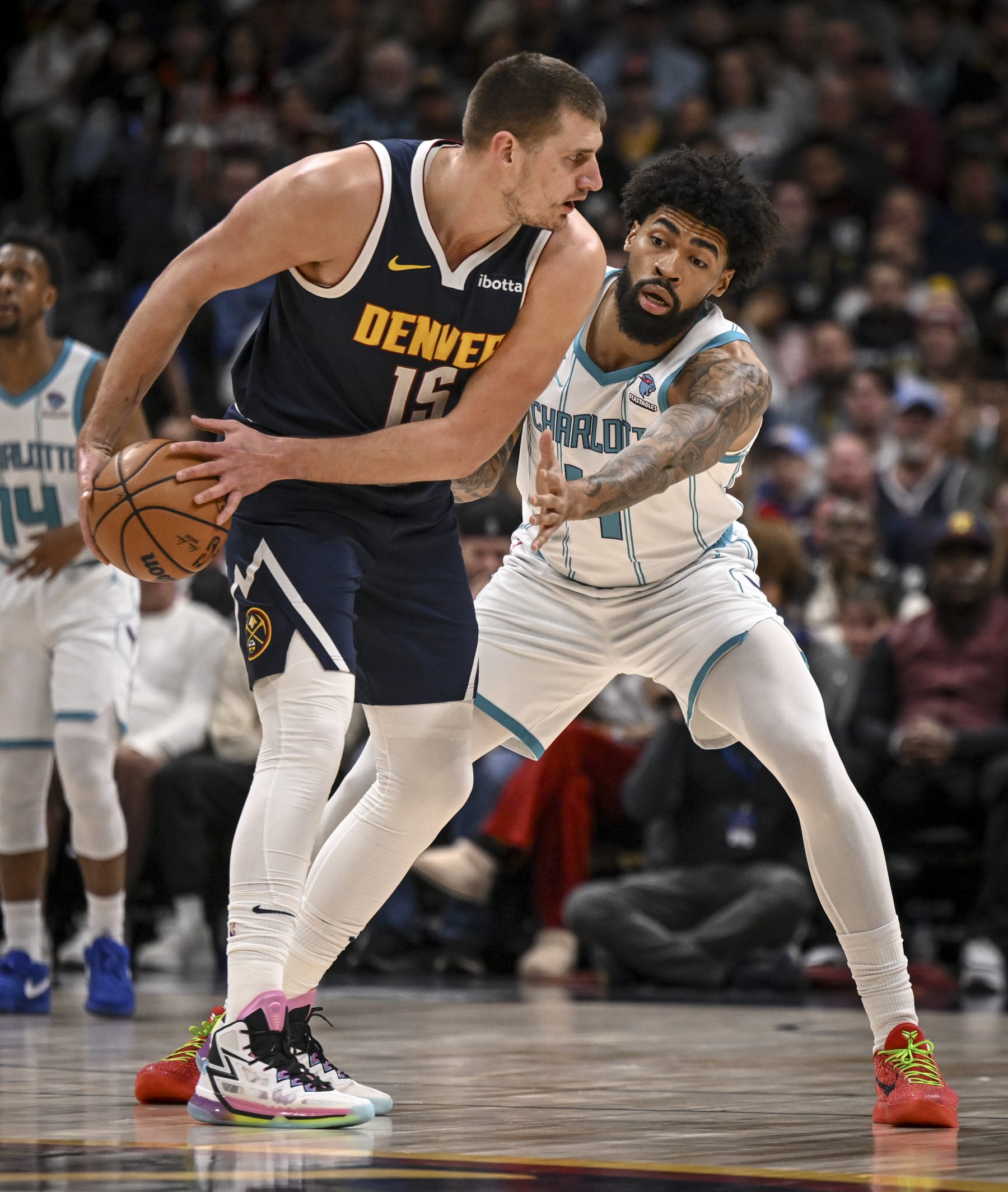 DENVER, CO - JANUARY 1: Nick Richards (4) of the Charlotte Hornets defends Nikola Jokic (15) of the Denver Nuggets during the first quarter at Ball Arena in Denver on Monday, January 1, 2024. (Photo by AAron Ontiveroz/The Denver Post)
