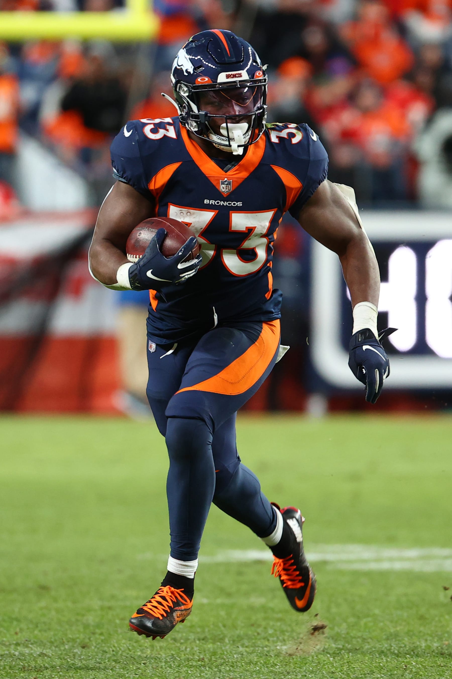 DENVER, COLORADO - JANUARY 08: Javonte Williams #33 of the Denver Broncos rushes during the second half against the Kansas City Chiefs at Empower Field At Mile High on January 08, 2022 in Denver, Colorado. (Photo by Jamie Schwaberow/Getty Images)