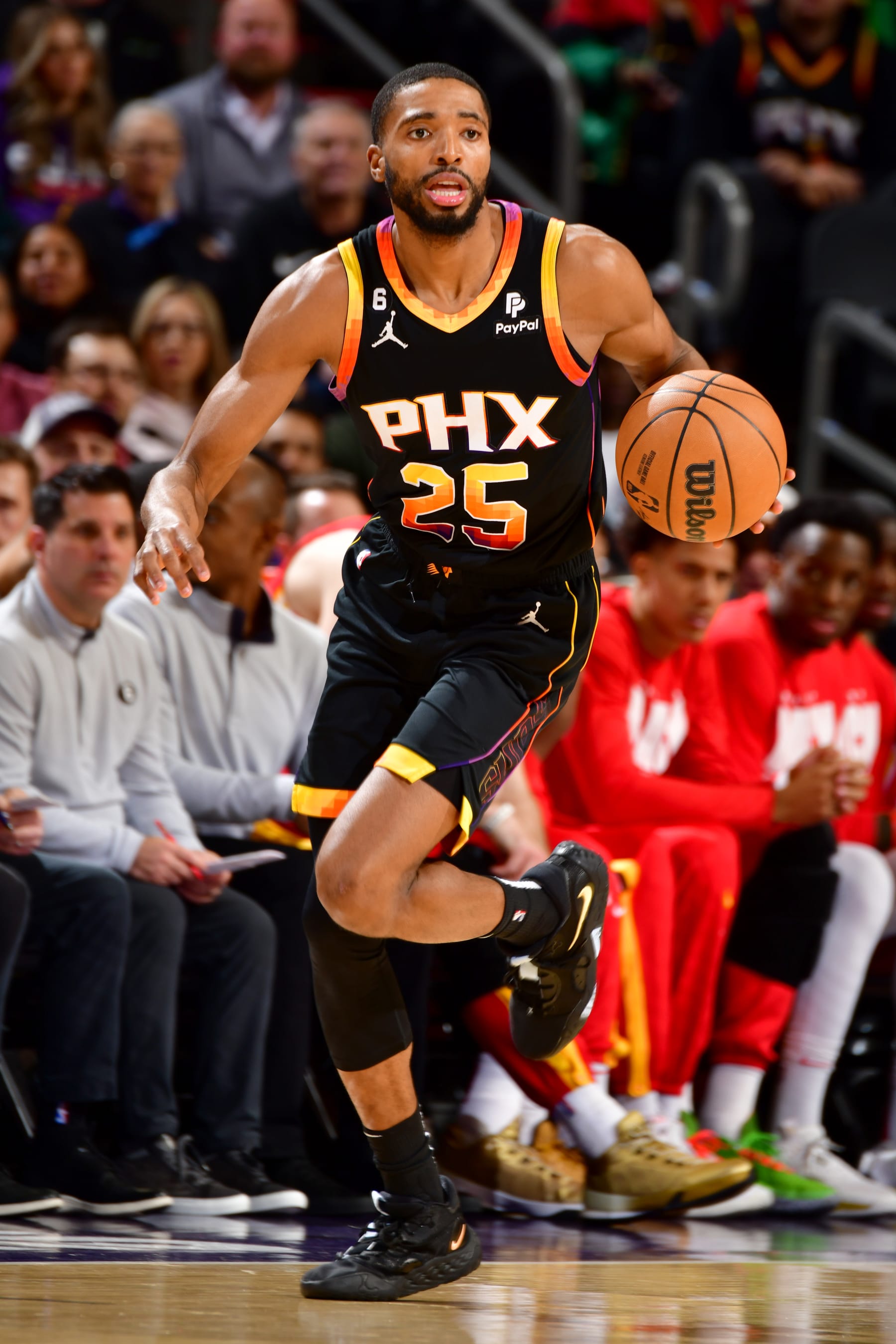 PHOENIX, AZ - FEBRUARY 1: Mikal Bridges #25 of the Phoenix Suns dribbles the ball during the game against the Atlanta Hawks on February 1, 2022 at Footprint Center in Phoenix, Arizona. NOTE TO USER: User expressly acknowledges and agrees that, by downloading and or using this photograph, user is consenting to the terms and conditions of the Getty Images License Agreement. Mandatory Copyright Notice: Copyright 2022 NBAE (Photo by Barry Gossage/NBAE via Getty Images)