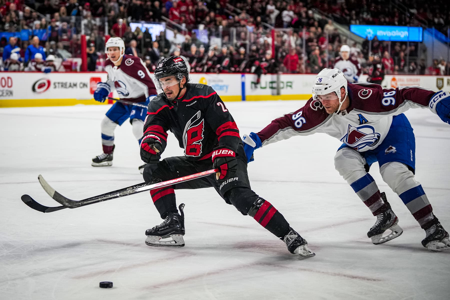 RALEIGH, NORTH CAROLINA - FEBRUARY 08: Seth Jarvis #24 of the Carolina Hurricanes is fouled by Mikko Rantanen #96 of the Colorado Avalanche on an empty-net breakaway during the third period at PNC Arena on February 08, 2024 in Raleigh, North Carolina. (Photo by Josh Lavallee/NHLI via Getty Images)