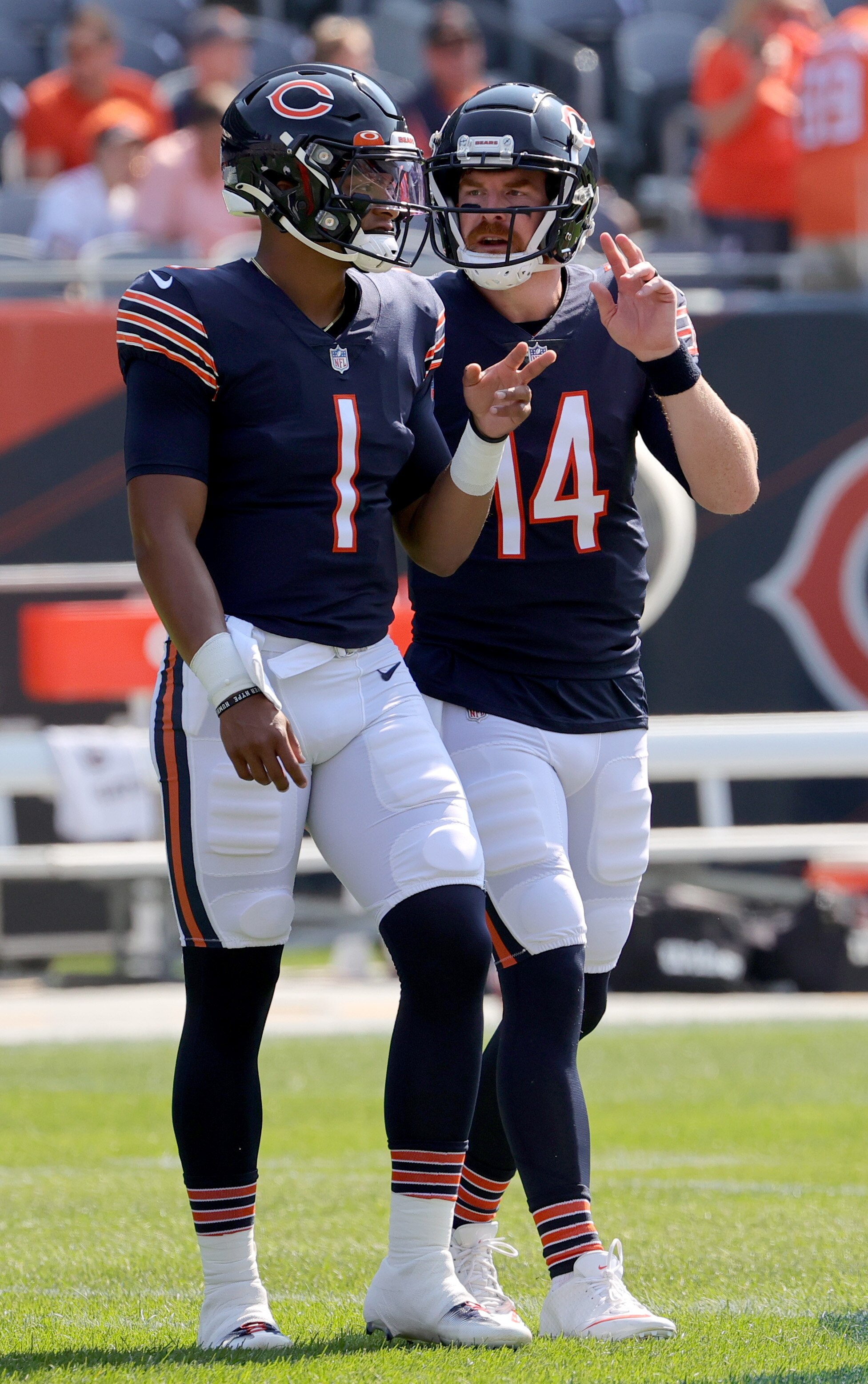 CHICAGO, ILLINOIS - SEPTEMBER 19: (L-R) Quarterback Justin Fields #1 talks with Quarterback Andy Dalton #14 of the Chicago Bears talks before the game against the Cincinnati Bengals at Soldier Field on September 19, 2021 in Chicago, Illinois. (Photo by Jonathan Daniel/Getty Images)