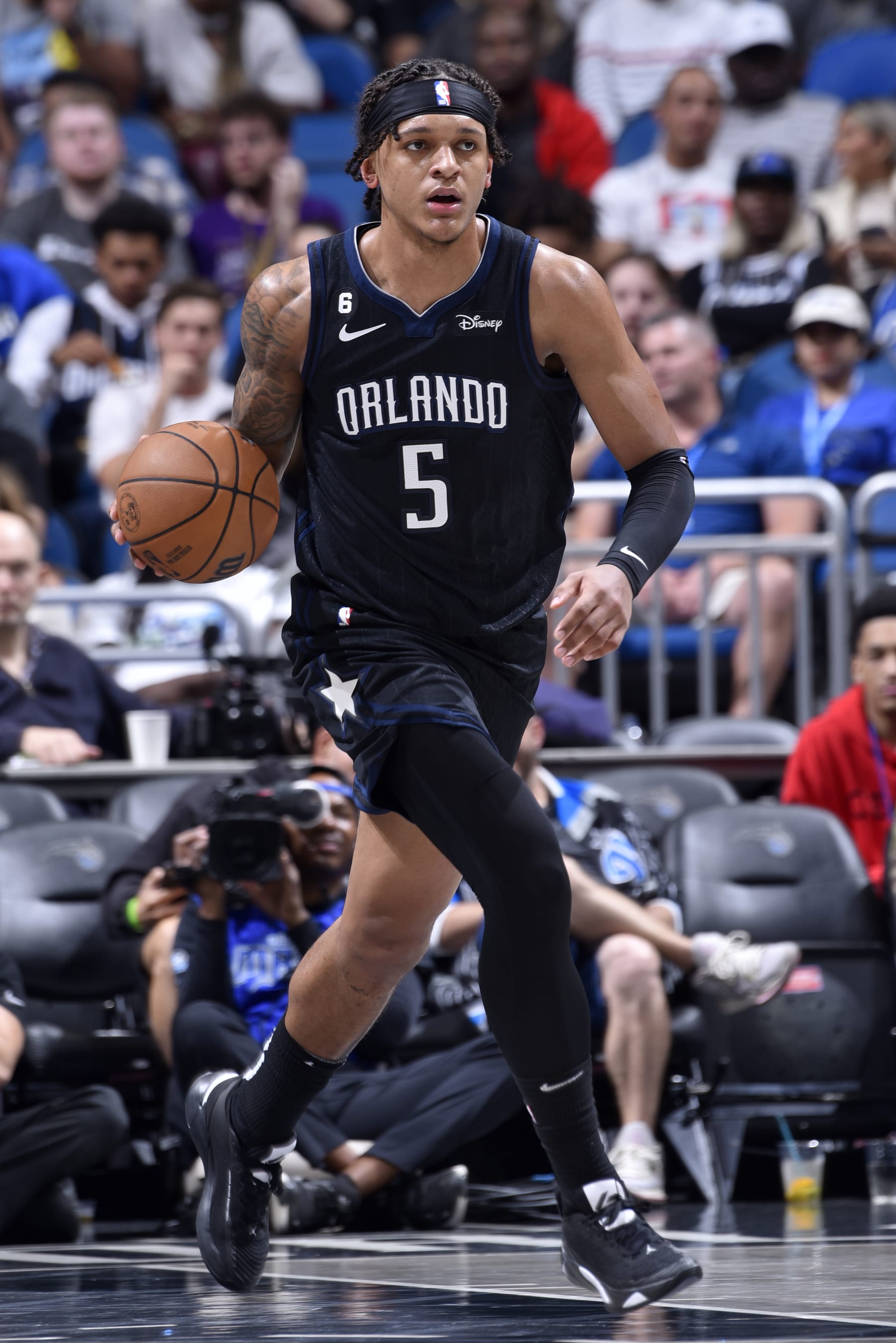 ORLANDO, FL - DECEMBER 14: Paolo Banchero #5 of the Orlando Magic dribbles the ball against the Atlanta Hawks on December 14, 2022 at Amway Center in Orlando, Florida. NOTE TO USER: User expressly acknowledges and agrees that, by downloading and or using this photograph, User is consenting to the terms and conditions of the Getty Images License Agreement. Mandatory Copyright Notice: Copyright 2022 NBAE (Photo by Gary Bassing/NBAE via Getty Images)