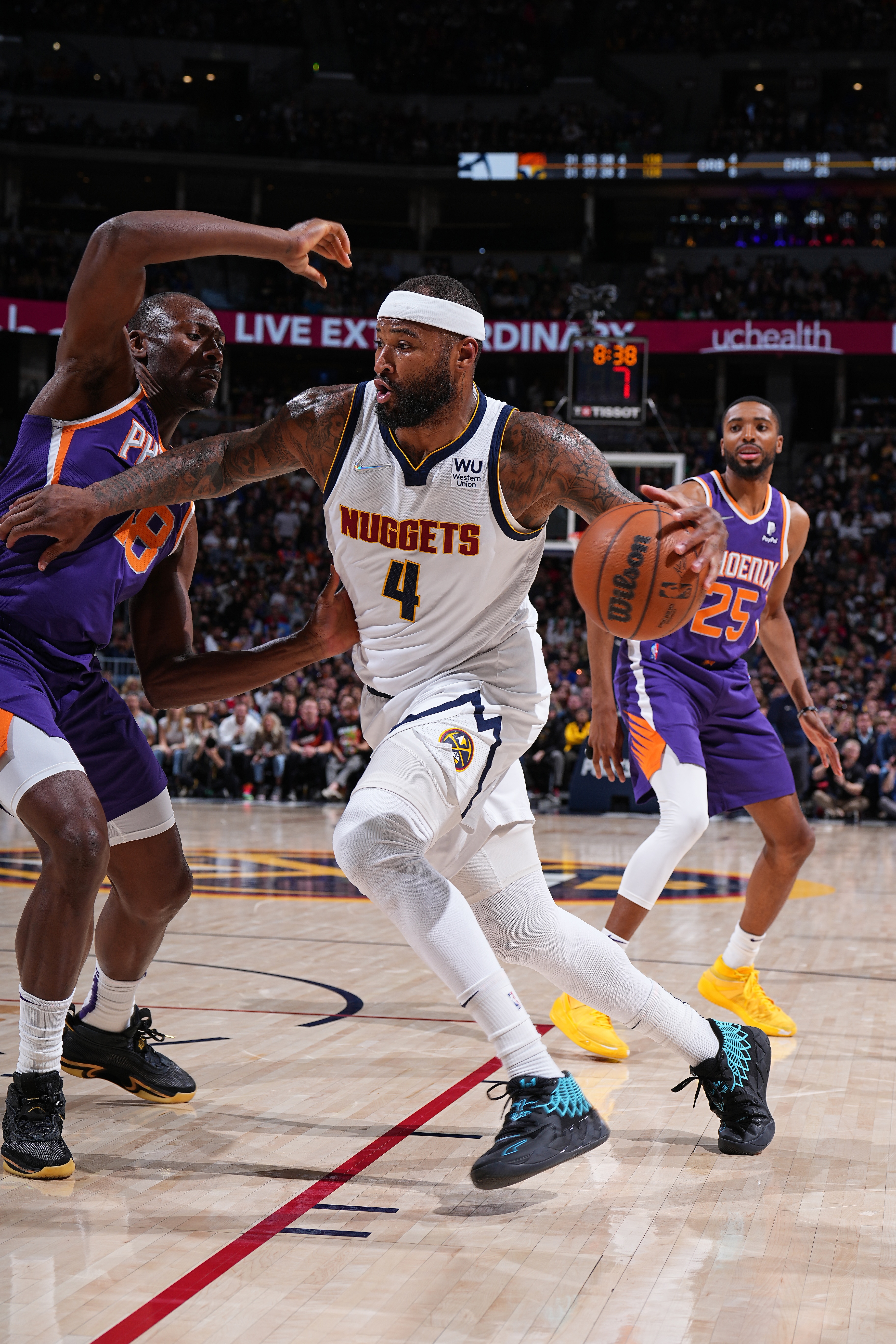 DENVER, CO - MARCH 24: DeMarcus Cousins #4 of the Denver Nuggets drives to the basket during the game against the Phoenix Suns on March 24, 2022 at the Ball Arena in Denver, Colorado. NOTE TO USER: User expressly acknowledges and agrees that, by downloading and/or using this Photograph, user is consenting to the terms and conditions of the Getty Images License Agreement. Mandatory Copyright Notice: Copyright 2022 NBAE (Photo by Garrett Ellwood/NBAE via Getty Images)