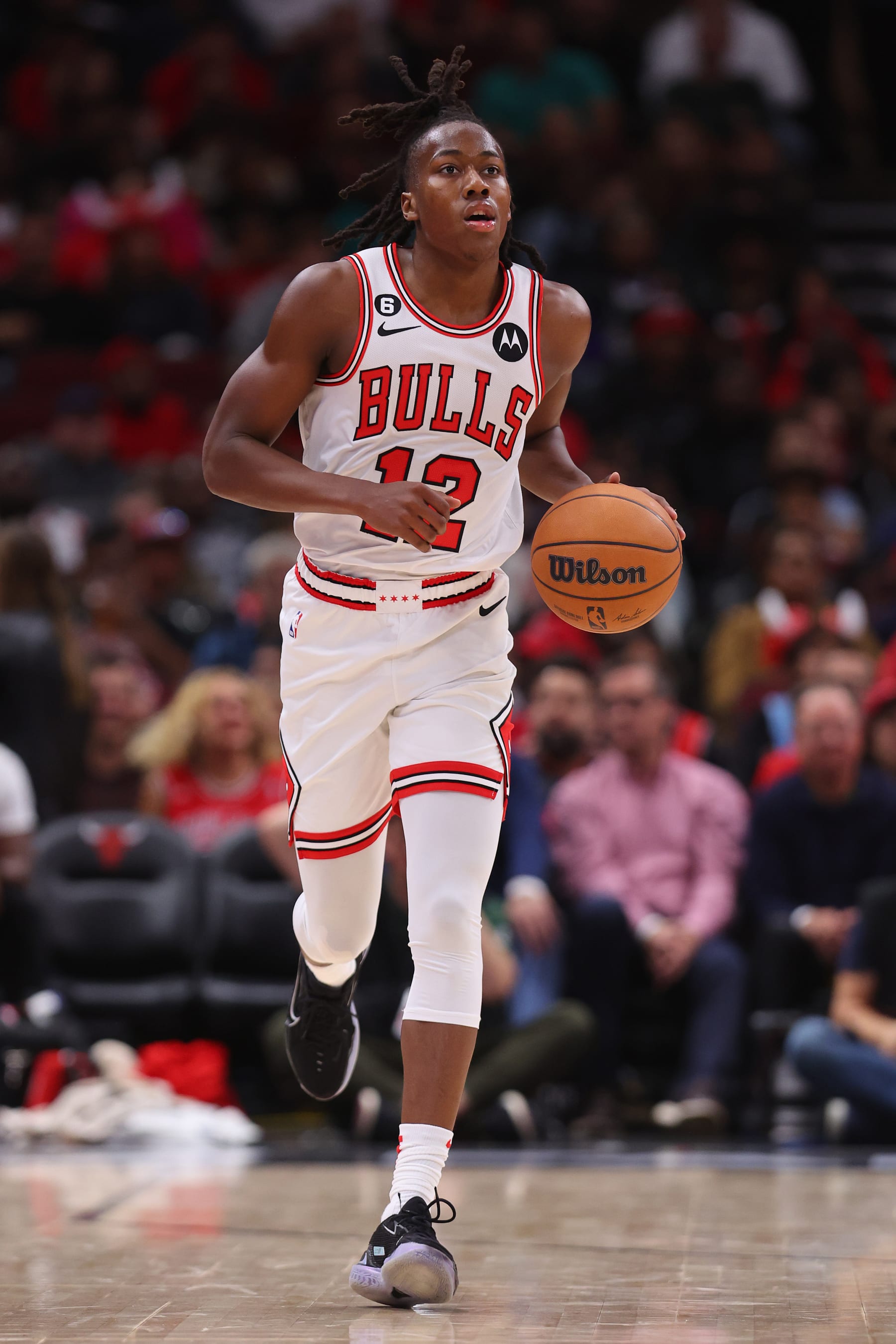 CHICAGO, ILLINOIS - OCTOBER 11: Ayo Dosunmu #12 of the Chicago Bulls dribbles up the court against the Milwaukee Bucks during the second half of a preseason game at United Center on October 11, 2022 in Chicago, Illinois. NOTE TO USER: User expressly acknowledges and agrees that, by downloading and or using this photograph, User is consenting to the terms and conditions of the Getty Images License Agreement. (Photo by Michael Reaves/Getty Images)
