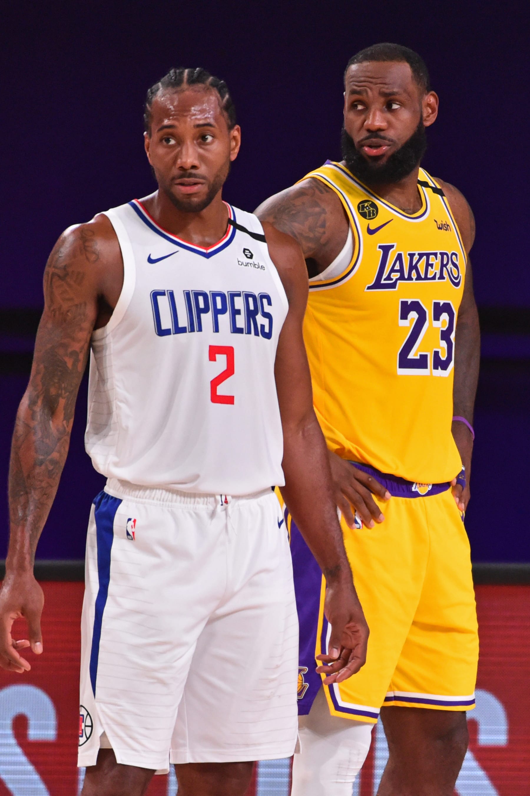Orlando, FL - JULY 30: Kawhi Leonard #2 of the LA Clippers and LeBron James #23 of the Los Angeles Lakers look on during the game on July 30, 2020 at The Arena at ESPN Wide World Of Sports Complex in Orlando, Florida. NOTE TO USER: User expressly acknowledges and agrees that, by downloading and/or using this Photograph, user is consenting to the terms and conditions of the Getty Images License Agreement. Mandatory Copyright Notice: Copyright 2020 NBAE (Photo by Jesse D. Garrabrant/NBAE via Getty Images)