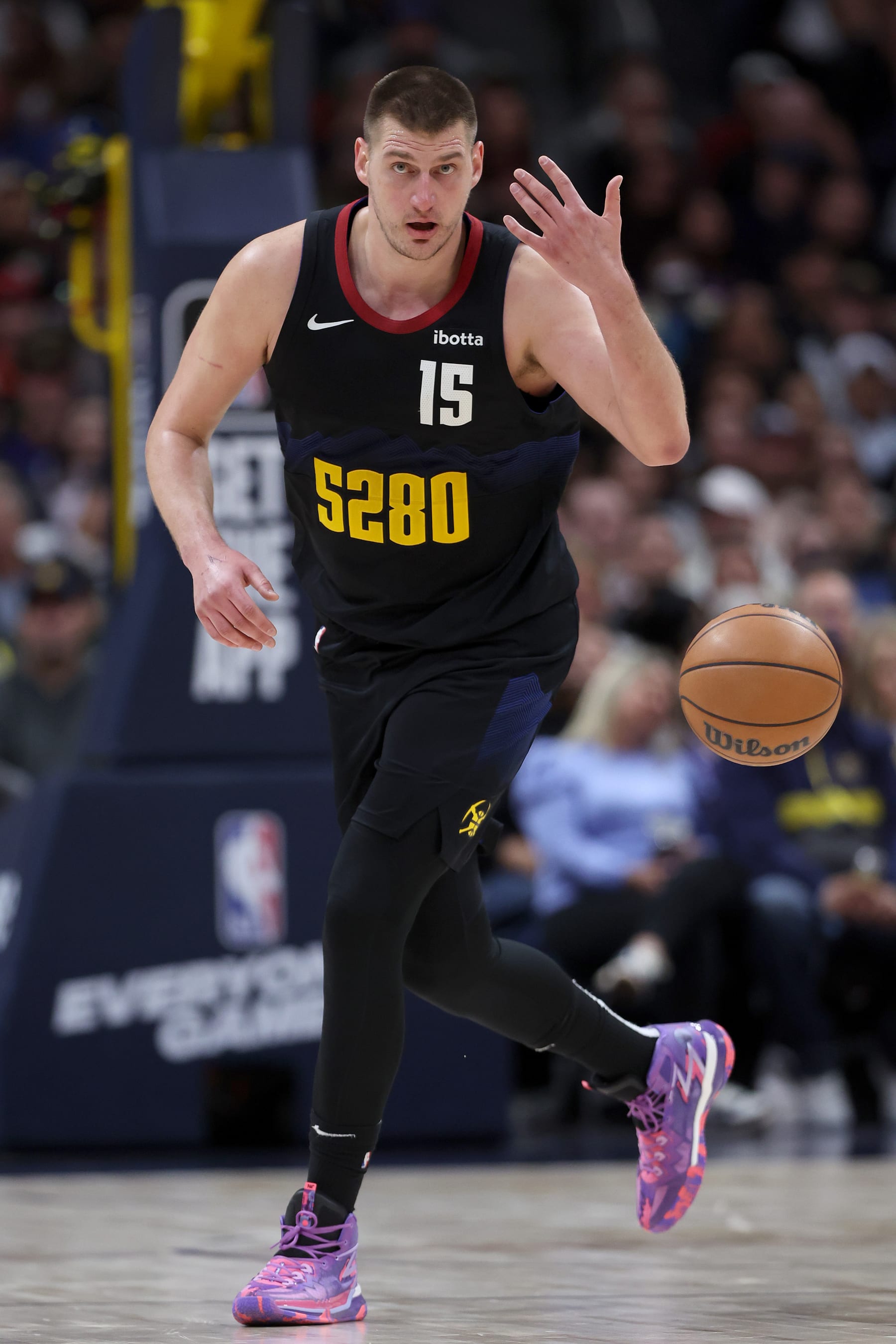 DENVER, COLORADO - MARCH 27: Nikola Jokic #15 of the Denver Nuggets brings the ball down the court against the Phoenix Suns during the third quarter at Ball Arena on March 27, 2024 in Denver, Colorado. NOTE TO USER: User expressly acknowledges and agrees that, by downloading and or using this photograph, User is consenting to the terms and conditions of the Getty Images License Agreement.  (Photo by Matthew Stockman/Getty Images)