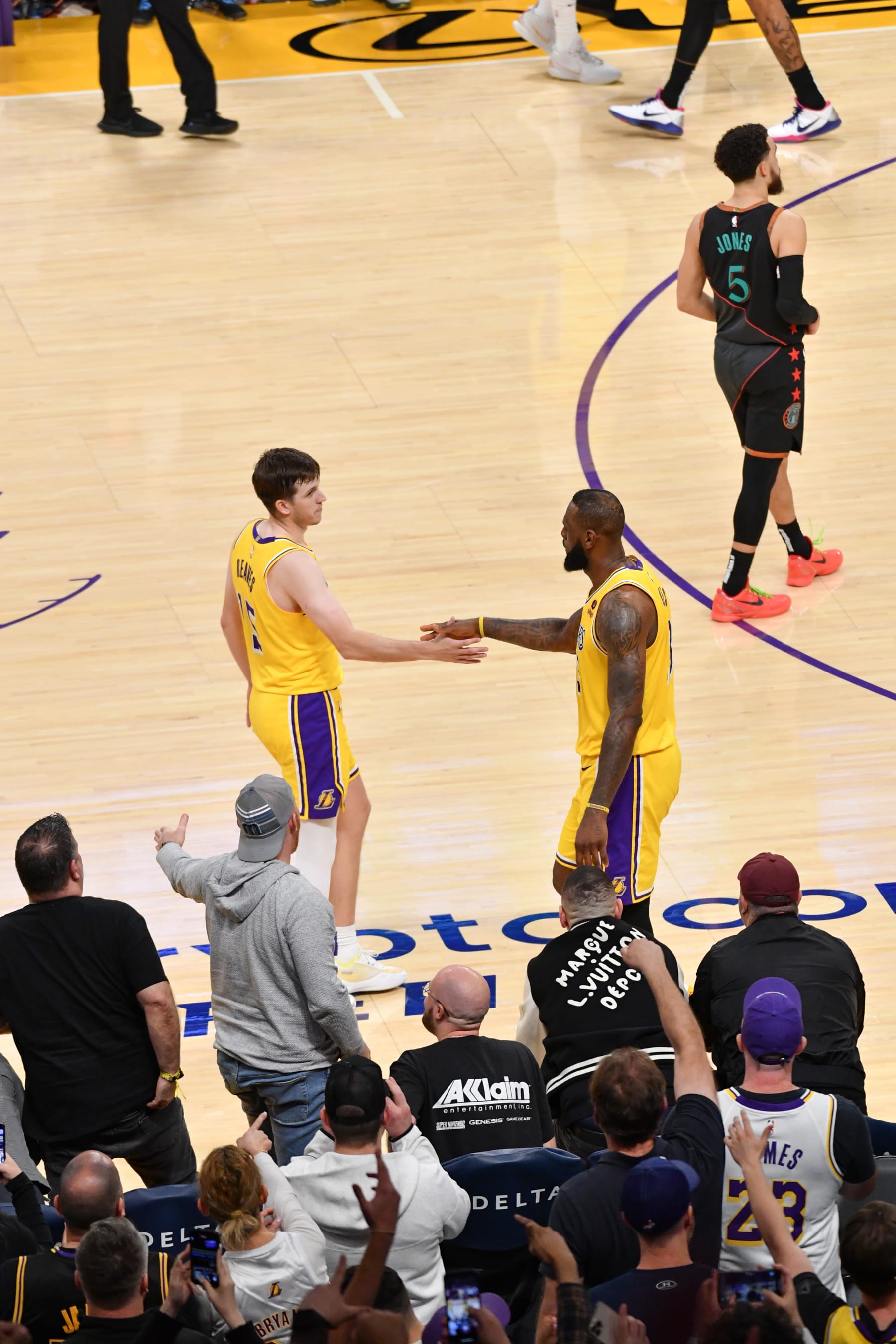 LOS ANGELES, CA - FEBRUARY 29:  Austin Reaves #15 of the Los Angeles Lakers & LeBron James #23 of the Los Angeles Lakers high five during the game on February 29, 2024 at Crypto.Com Arena in Los Angeles, California. NOTE TO USER: User expressly acknowledges and agrees that, by downloading and/or using this Photograph, user is consenting to the terms and conditions of the Getty Images License Agreement. Mandatory Copyright Notice: Copyright 2024 NBAE (Photo by Juan Ocampo/NBAE via Getty Images)