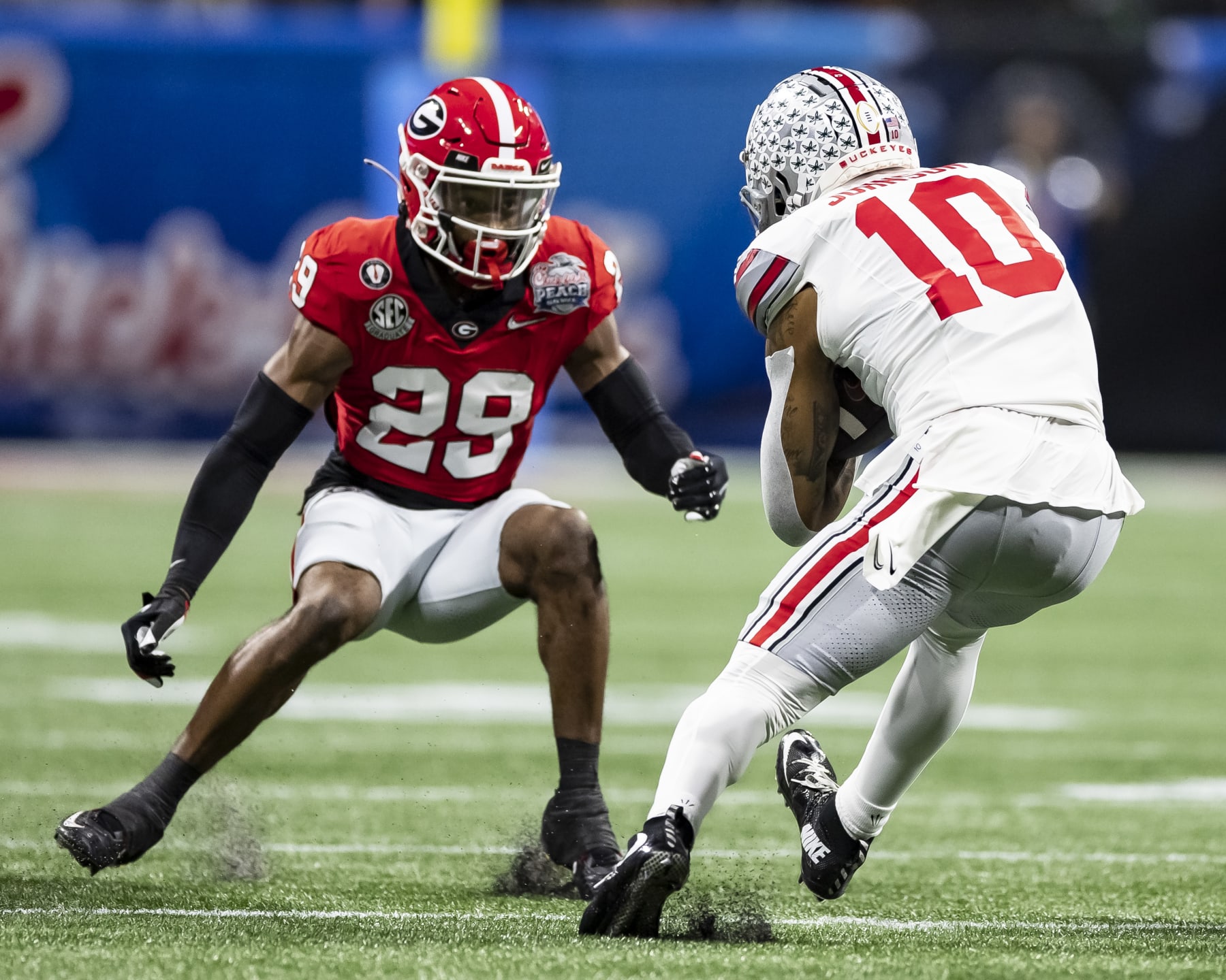 ATLANTA, GA - DECEMBER 31: Christopher Smith #29 of the Georgia Bulldogs confronts Xavier Johnson #10 of the Ohio State Buckeyes during a game between Ohio State Buckeyes and Georgia Bulldogs at Mercedes-Benz Stadium on December 31, 2022 in Atlanta, Georgia. (Photo by Steve Limentani/ISI Photos/Getty Images)
