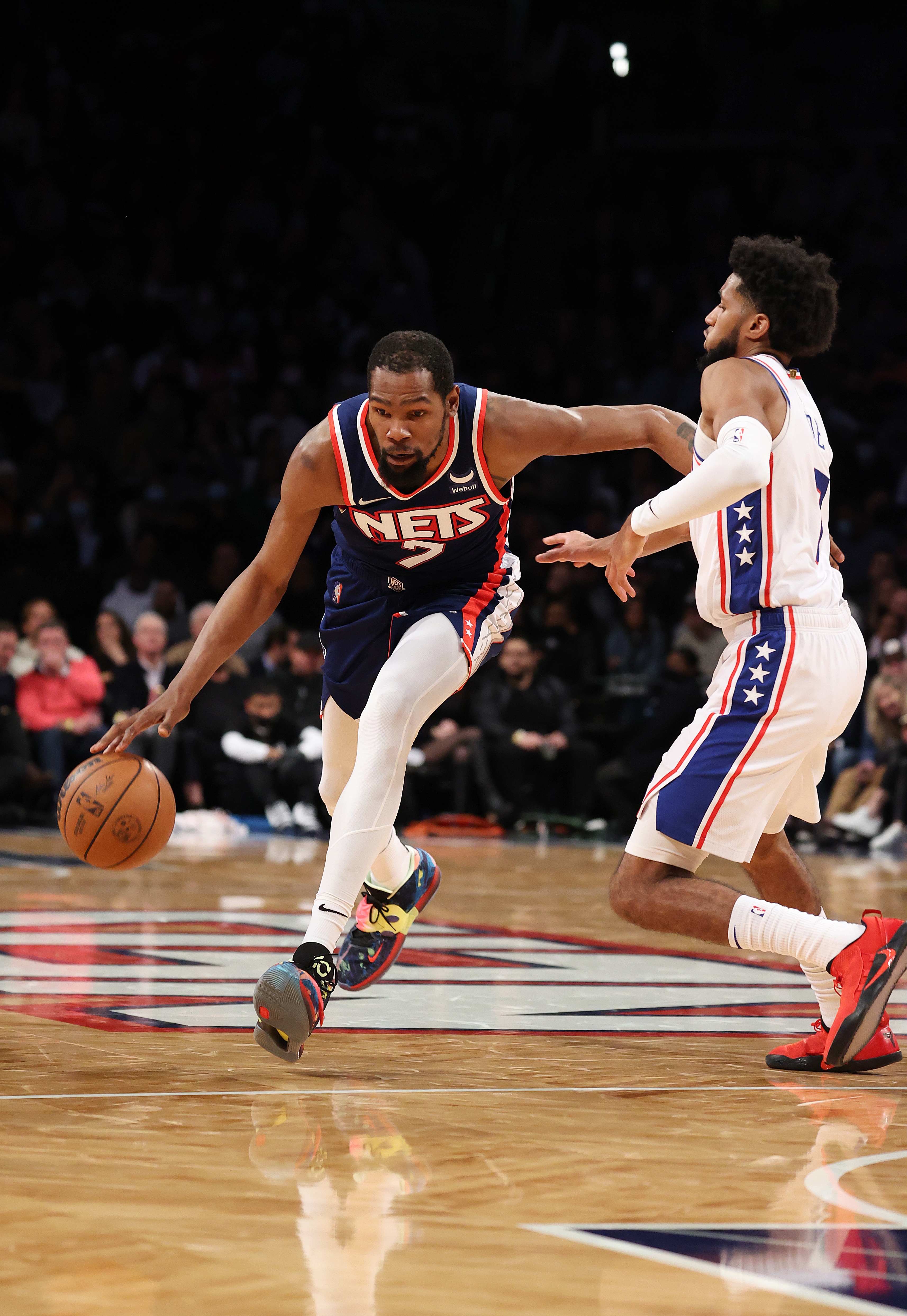 NEW YORK, NEW YORK - DECEMBER 16:   Kevin Durant #7 of the Brooklyn Nets drives against Isaiah Joe #7 of the Philadelphia 76ers during their game at Barclays Center on December 16, 2021 in New York City.   NOTE TO USER: User expressly acknowledges and agrees that, by downloading and or using this photograph, User is consenting to the terms and conditions of the Getty Images License Agreement. (Photo by Al Bello/Getty Images)