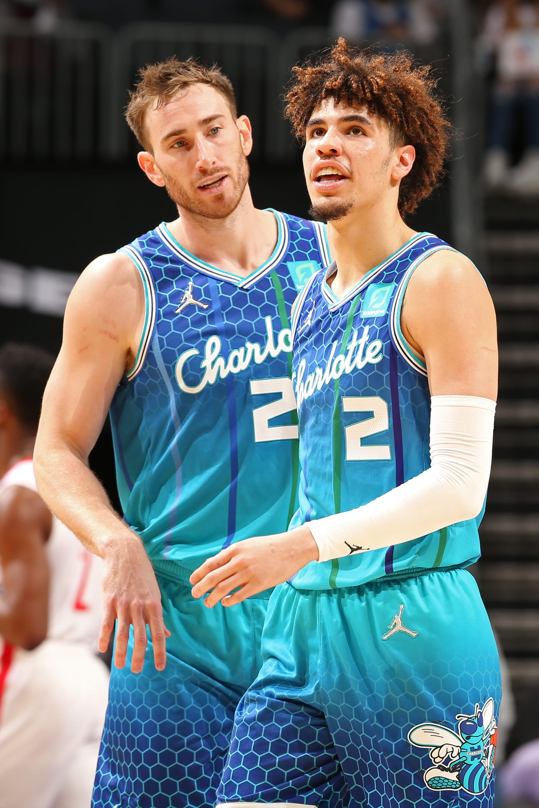 CHARLOTTE, NC - JANUARY 1: Gordon Hayward #20 and LaMelo Ball #2 of the Charlotte Hornets look on during the game against Houston Rockets on January 1, 2022 at Spectrum Center in Charlotte, North Carolina. NOTE TO USER: User expressly acknowledges and agrees that, by downloading and or using this photograph, User is consenting to the terms and conditions of the Getty Images License Agreement. Mandatory Copyright Notice: Copyright 2022 NBAE (Photo by Kent Smith/NBAE via Getty Images)