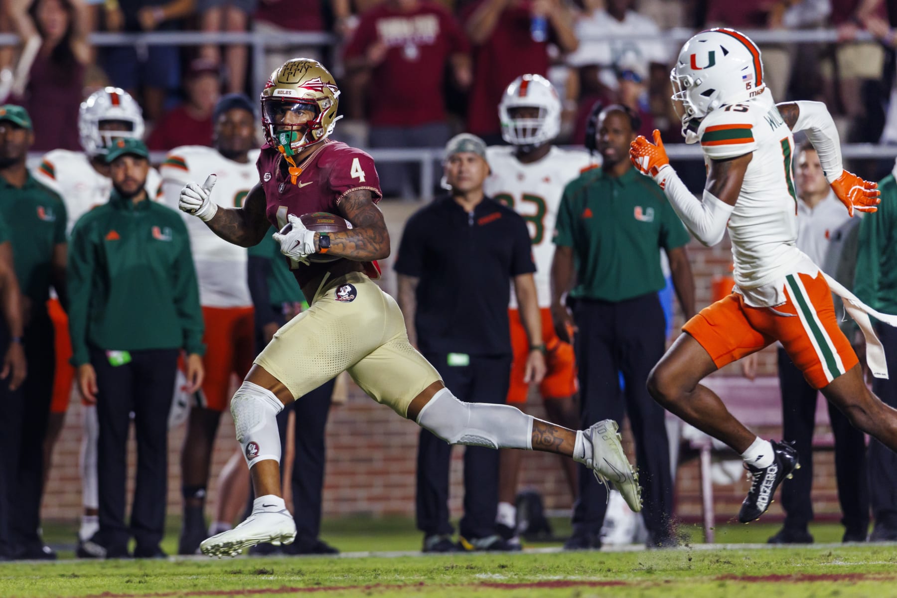 Florida State's Keon Coleman (4) is chased by Miami defensive back Markeith Williams (15) as he makes a 57-yard punt return during the second half of an NCAA college football game, Saturday, Nov. 11, 2023, in Tallahassee, Fla. (AP Photo/Colin Hackley)