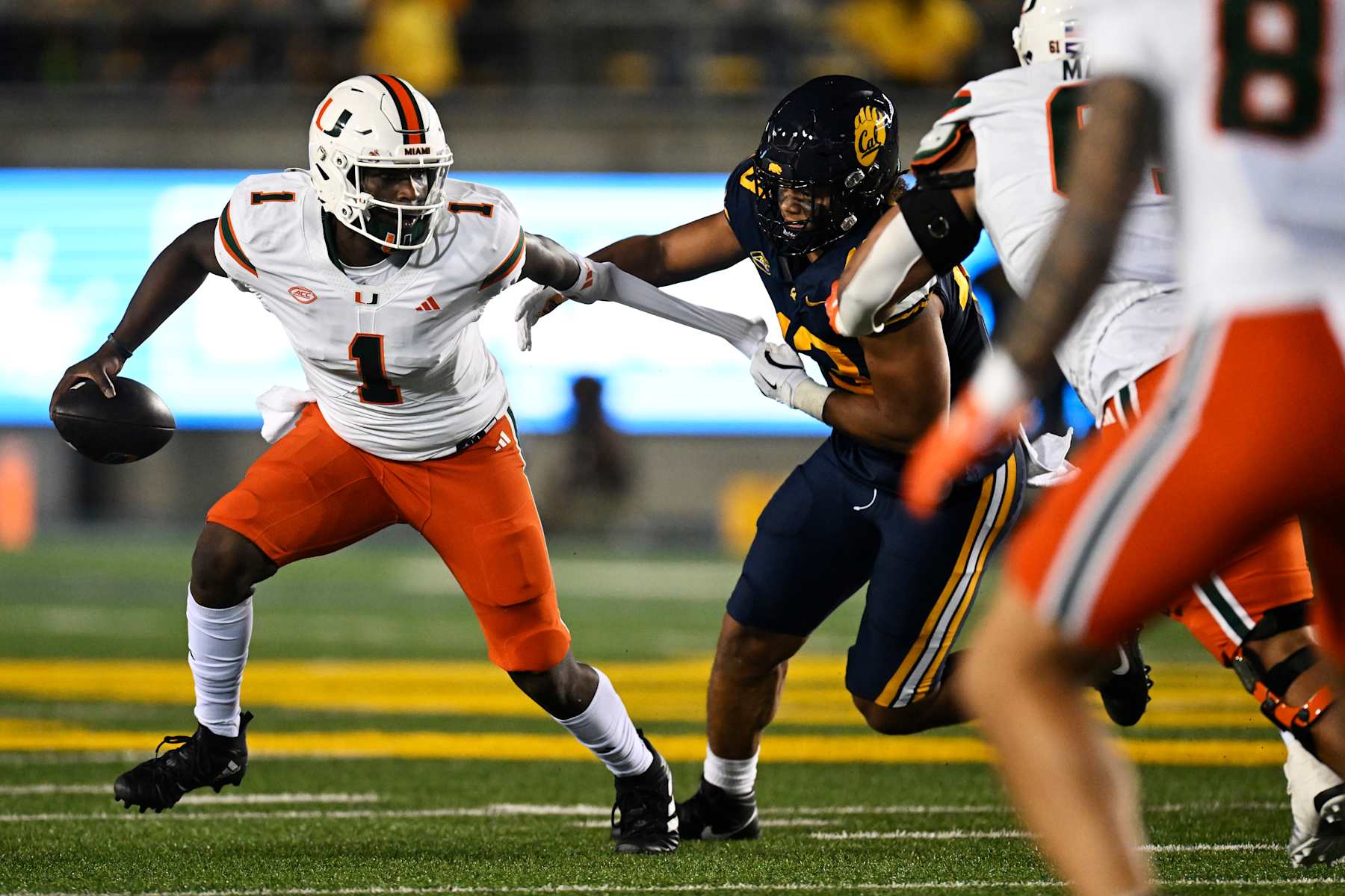 BERKELEY, CALIFORNIA - OCTOBER 05: Cam Ward #1 of the Miami Hurricanes evades a tackle by Ryan McCulloch #43 of the California Golden Bears in the second half at California Memorial Stadium on October 05, 2024 in Berkeley, California. (Photo by Eakin Howard/Getty Images)