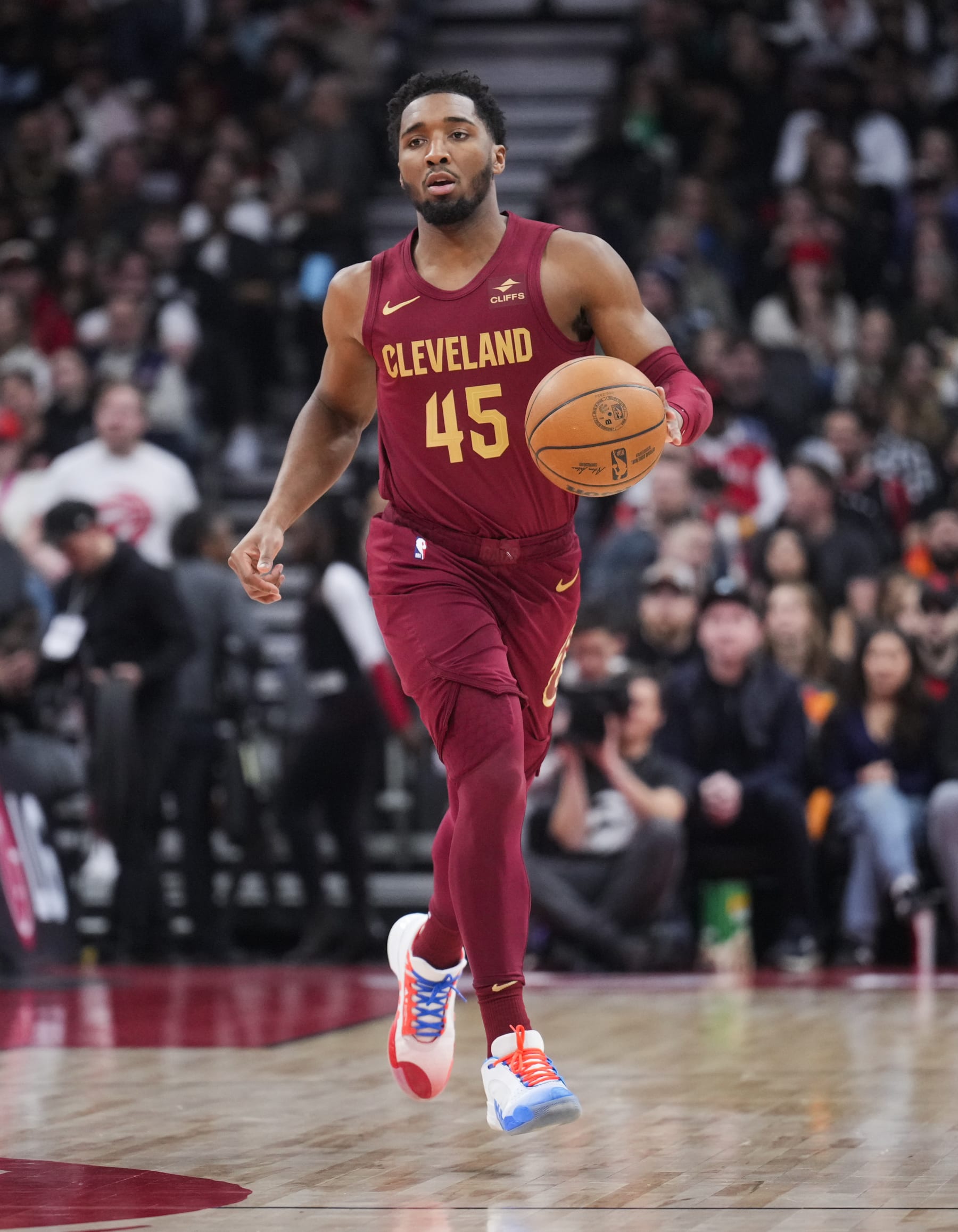 TORONTO, ON - JANUARY 1: Donovan Mitchell #45 of Cleveland Cavaliers dribbles against the Cleveland Cavaliers during the first half of their basketball game at the Scotiabank Arena on January 1, 2024 in Toronto, Ontario, Canada. NOTE TO USER: User expressly acknowledges and agrees that, by downloading and/or using this Photograph, user is consenting to the terms and conditions of the Getty Images License Agreement. (Photo by Mark Blinch/Getty Images)
