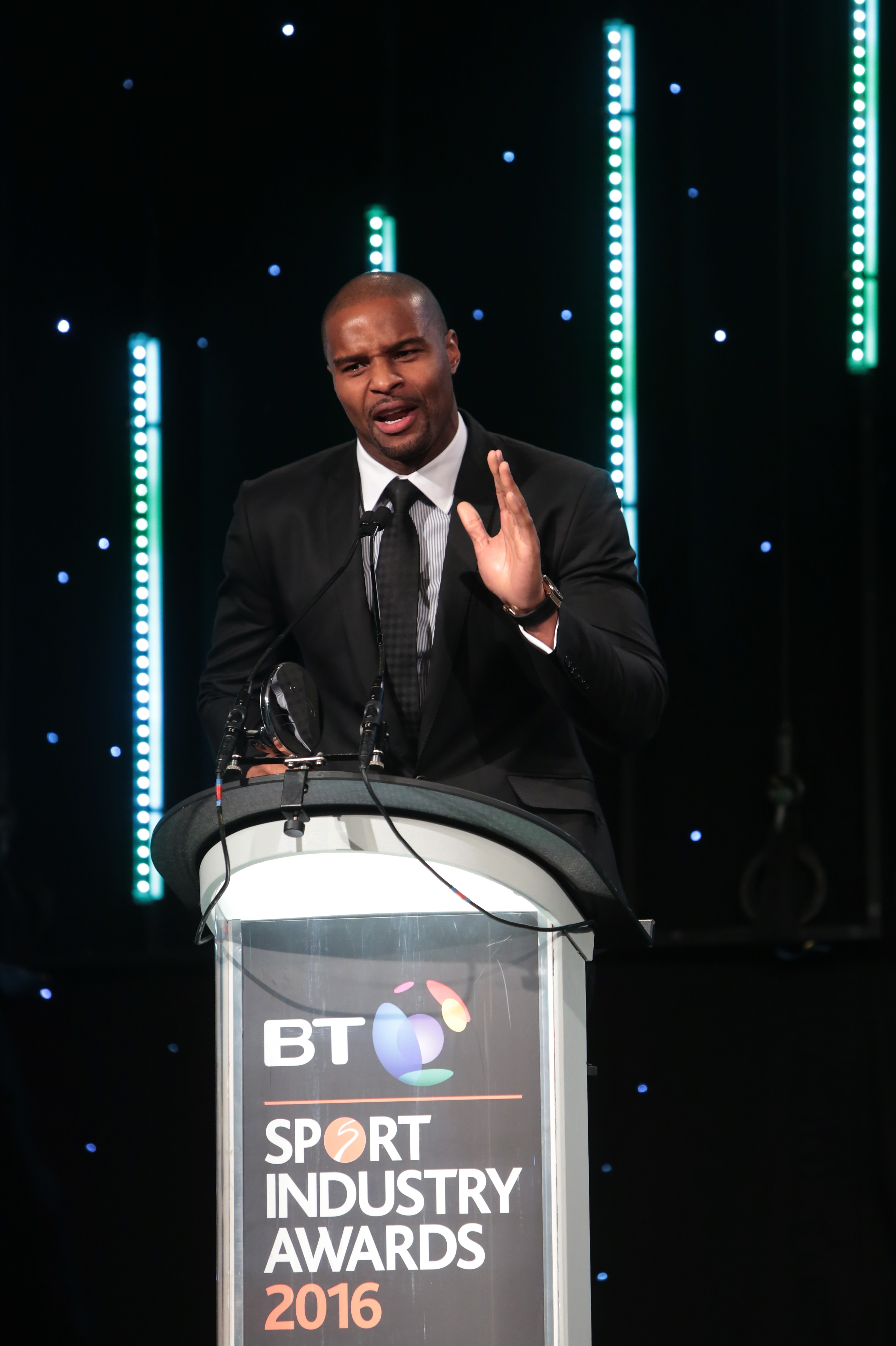 LONDON, ENGLAND - APRIL 28:  Osi Umenyiora presents Brand of the Year in association with Pinsent Masons to adidas at the BT Sport Industry Awards 2016 at Battersea Evolution on April 28, 2016 in London, England. The BT Sport Industry Awards is the most prestigious commercial sports awards ceremony in Europe, where over 1750 of the industry's key decision-makers mix with high profile sporting celebrities for the most important networking occasion in the sport business calendar.  (Photo by Claire Greenway/Getty Images for BT Sport Industry Awards)