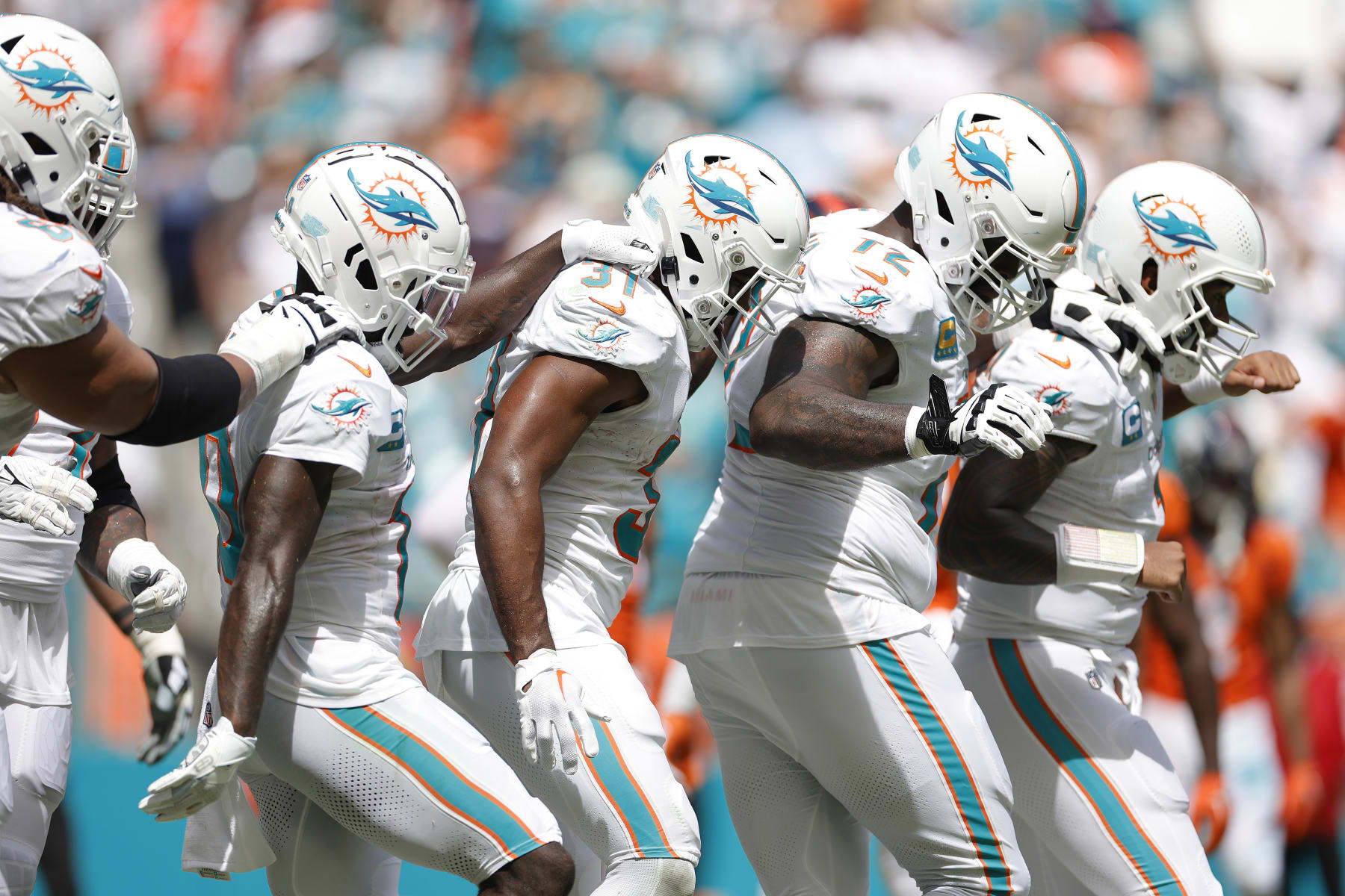 MIAMI GARDENS, FLORIDA - SEPTEMBER 24: Tyreek Hill #10 of the Miami Dolphins and Raheem Mostert #31 of the Miami Dolphins, Terron Armstead #72 of the Miami Dolphins, and Tua Tagovailoa #1 of the Miami Dolphins celebrate after Mostert's rushing touchdown during the second quarter against the Denver Broncos at Hard Rock Stadium on September 24, 2023 in Miami Gardens, Florida. (Photo by Carmen Mandato/Getty Images)