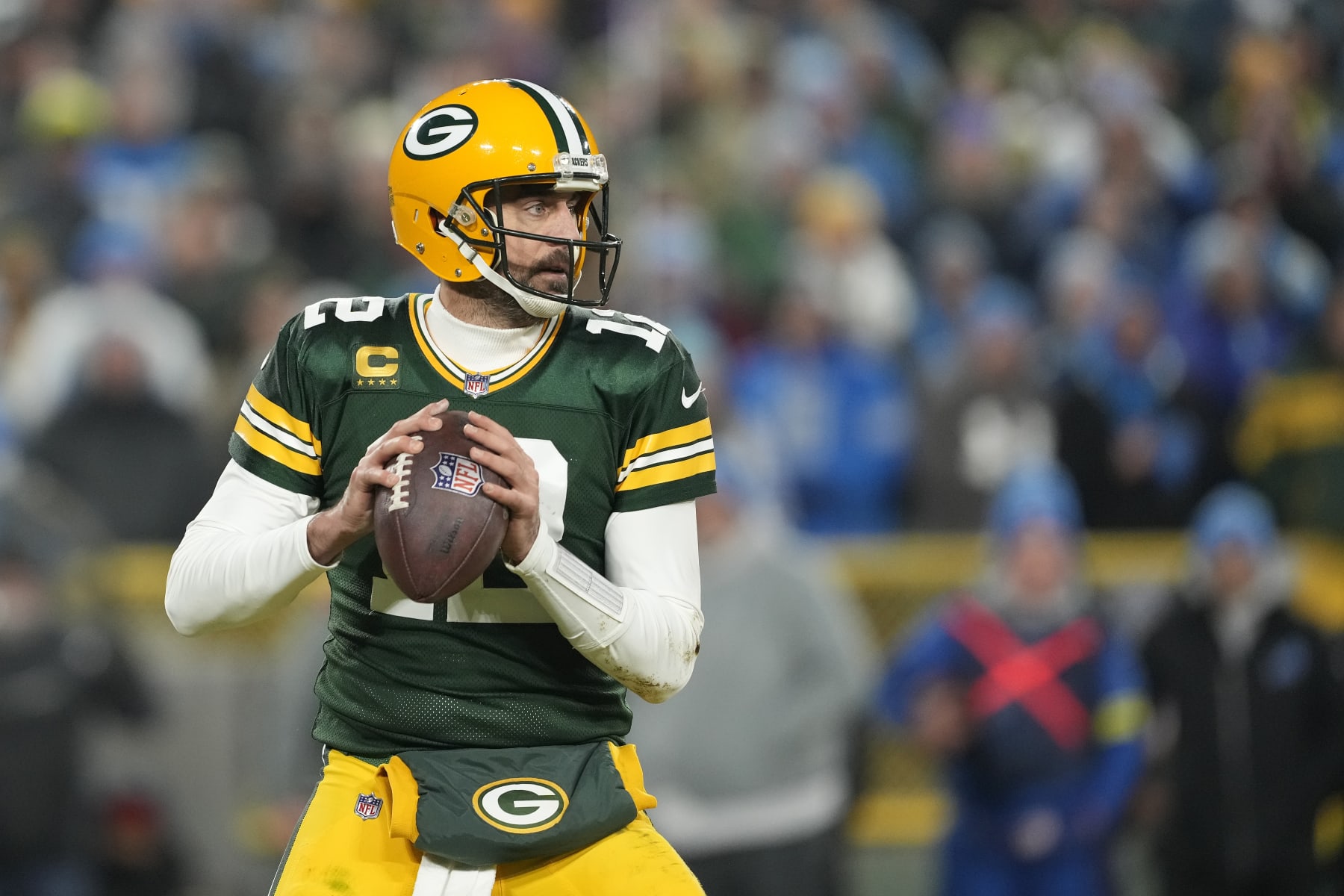 GREEN BAY, WISCONSIN - JANUARY 08: Aaron Rodgers #12 of the Green Bay Packers looks to the throw the pass against the Detroit Lions in the second half at Lambeau Field on January 08, 2023 in Green Bay, Wisconsin. (Photo by Patrick McDermott/Getty Images)