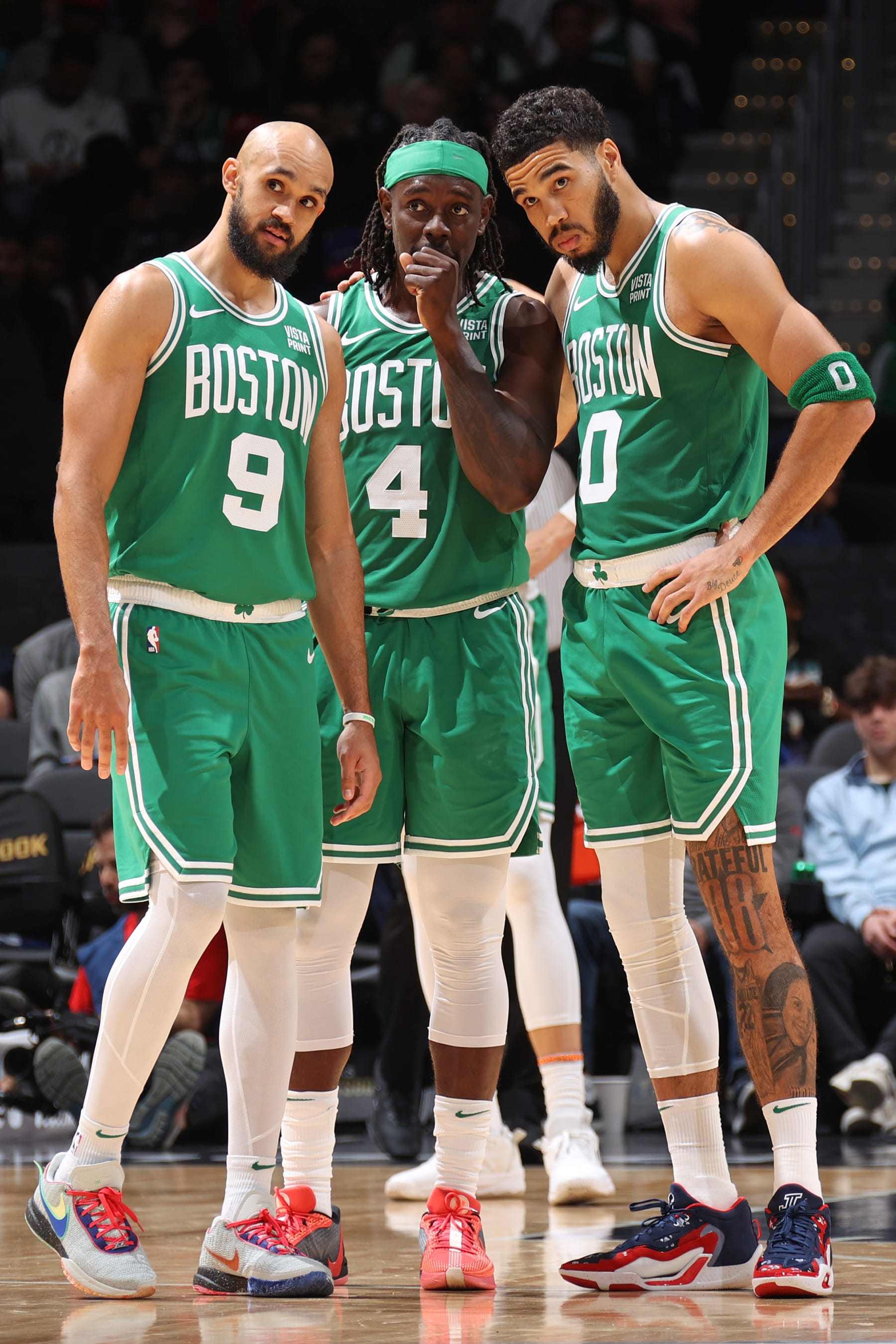 WASHINGTON, DC -  OCTOBER 30: Derrick White #9, Jrue Holiday #4 and Jayson Tatum #0 of the Boston Celtics look on during the game against the Washington Wizards on October 30, 2023 at Capital One Arena in Washington, DC. NOTE TO USER: User expressly acknowledges and agrees that, by downloading and or using this Photograph, user is consenting to the terms and conditions of the Getty Images License Agreement. Mandatory Copyright Notice: Copyright 2023 NBAE (Photo by Stephen Gosling/NBAE via Getty Images)