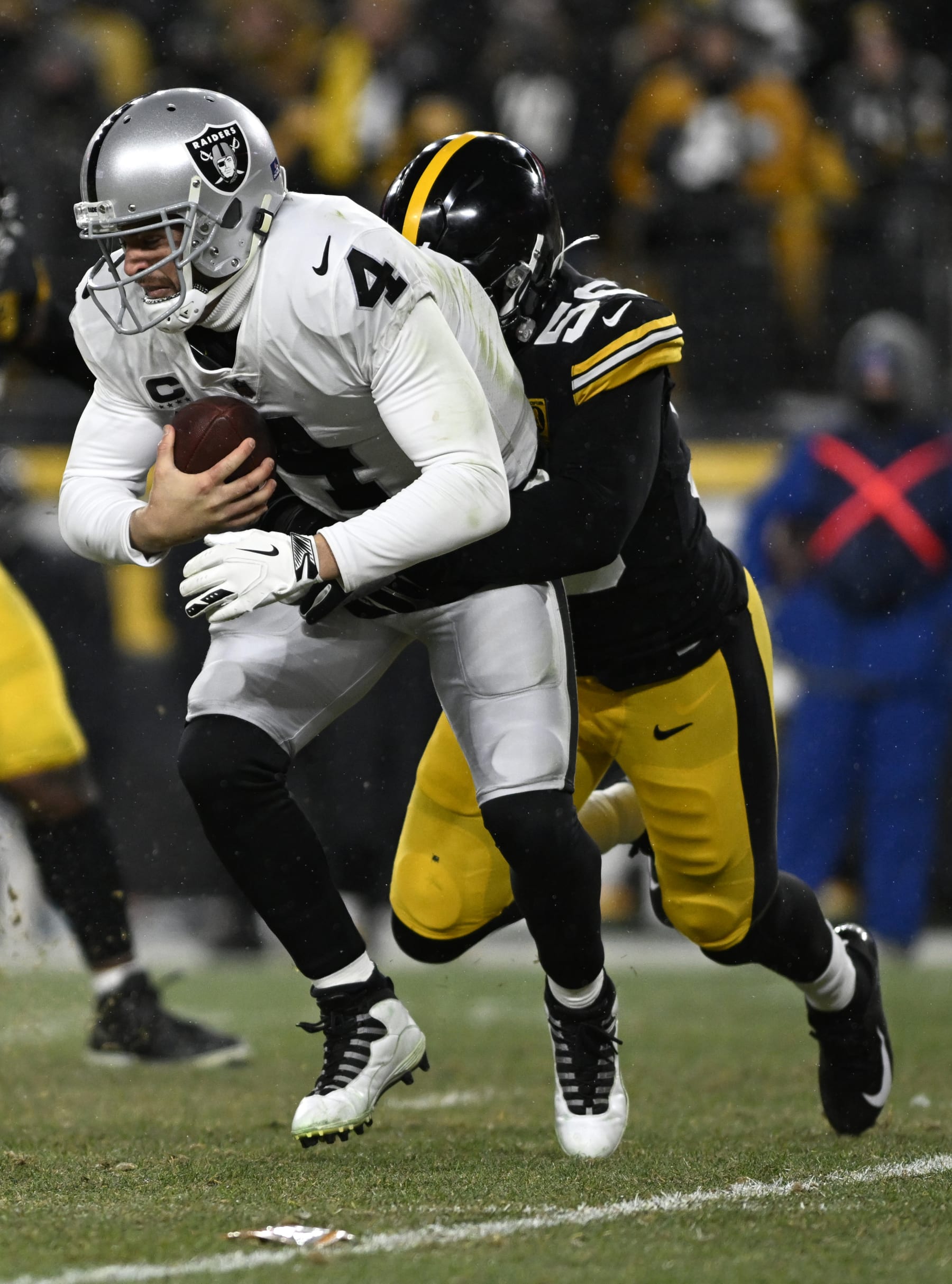 PITTSBURGH, PENNSYLVANIA - DECEMBER 24: Derek Carr #4 of the Las Vegas Raiders is sacked by Alex Highsmith #56 of the Pittsburgh Steelers during the third quarter  at Acrisure Stadium on December 24, 2022 in Pittsburgh, Pennsylvania. (Photo by Gaelen Morse/Getty Images)