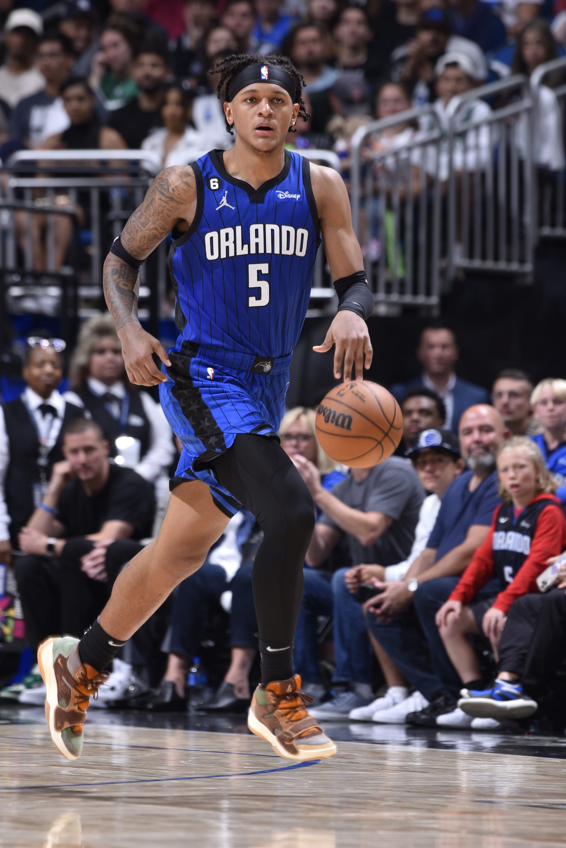 ORLANDO, FL - OCTOBER 22: Paolo Banchero #5 of the Orlando Magic handles the ball during the game against the Boston Celtics on October 22, 2022 at Amway Center in Orlando, Florida. NOTE TO USER: User expressly acknowledges and agrees that, by downloading and or using this photograph, User is consenting to the terms and conditions of the Getty Images License Agreement. Mandatory Copyright Notice: Copyright 2022 NBAE (Photo by Gary Bassing/NBAE via Getty Images)