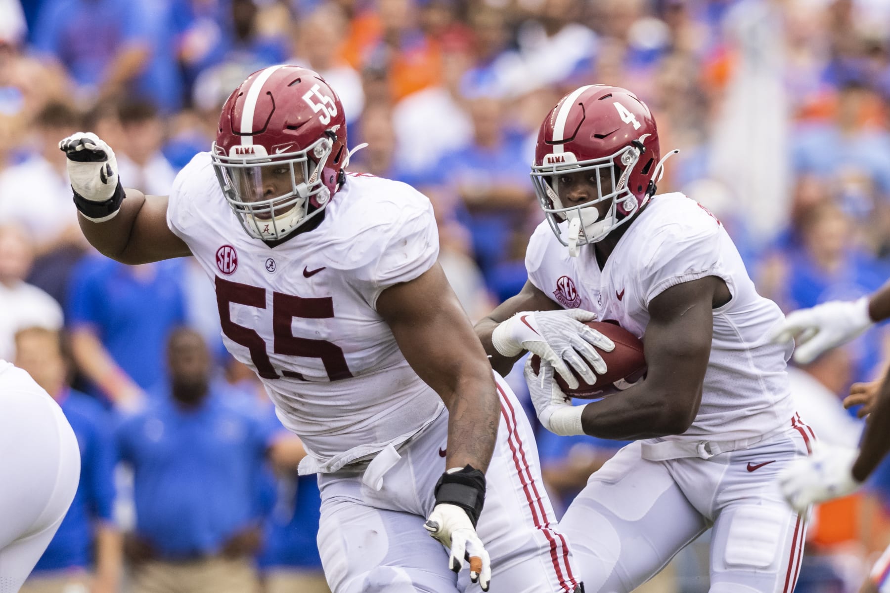 GAINESVILLE, FLORIDA - SEPTEMBER 18: Emil Ekiyor Jr. #55 of the Alabama Crimson Tide blocks as Brian Robinson Jr. #4 runs for yardage during the first quarter of a game against the Florida Gators at Ben Hill Griffin Stadium on September 18, 2021 in Gainesville, Florida. (Photo by James Gilbert/Getty Images)