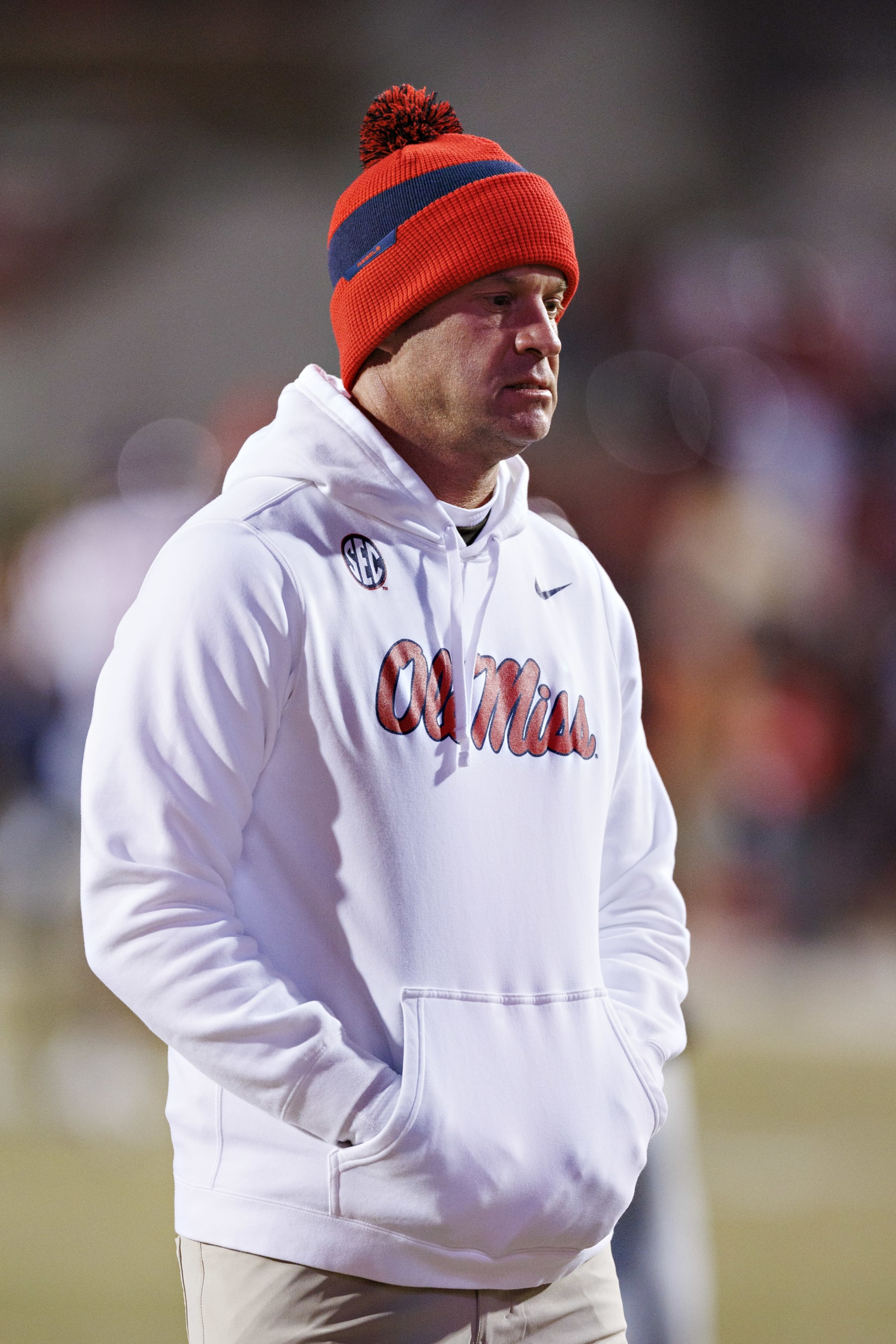 FAYETTEVILLE, ARKANSAS - NOVEMBER 19: Head Coach Lane Kiffin of the Mississippi Rebels watches his team warm up before a game against the Arkansas Razorbacks at Donald W. Reynolds Razorback Stadium on November 19, 2022 in Fayetteville, Arkansas. (Photo by Wesley Hitt/Getty Images)