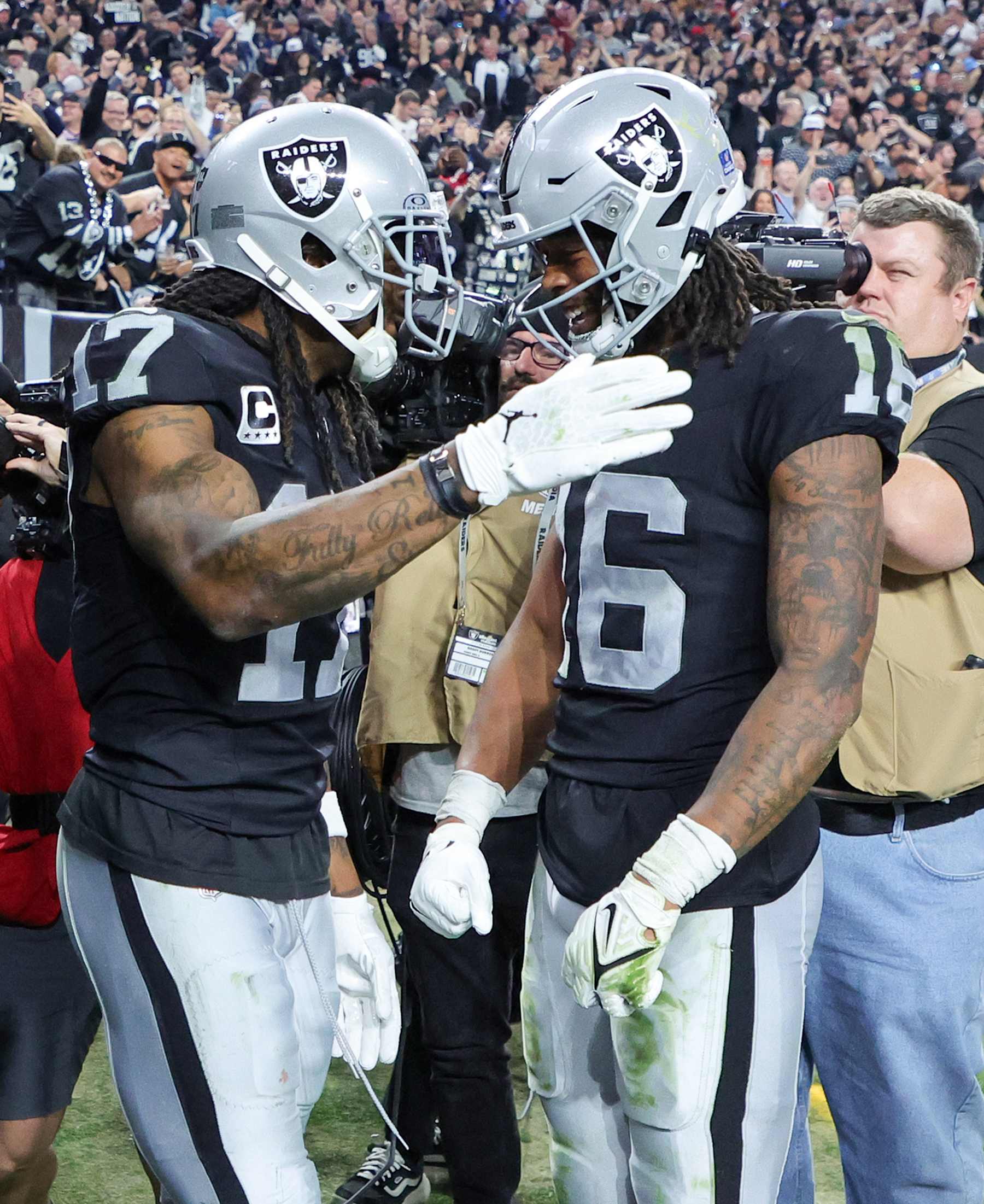 LAS VEGAS, NEVADA - DECEMBER 14: Wide receivers Davante Adams #17 and Jakobi Meyers #16 of the Las Vegas Raiders celebrate in the end zone after Meyers threw a touchdown pass to Adams in the third quarter of their game against the Los Angeles Chargers at Allegiant Stadium on December 14, 2023 in Las Vegas, Nevada. The Raiders defeated the Chargers 63-21. (Photo by Ethan Miller/Getty Images)