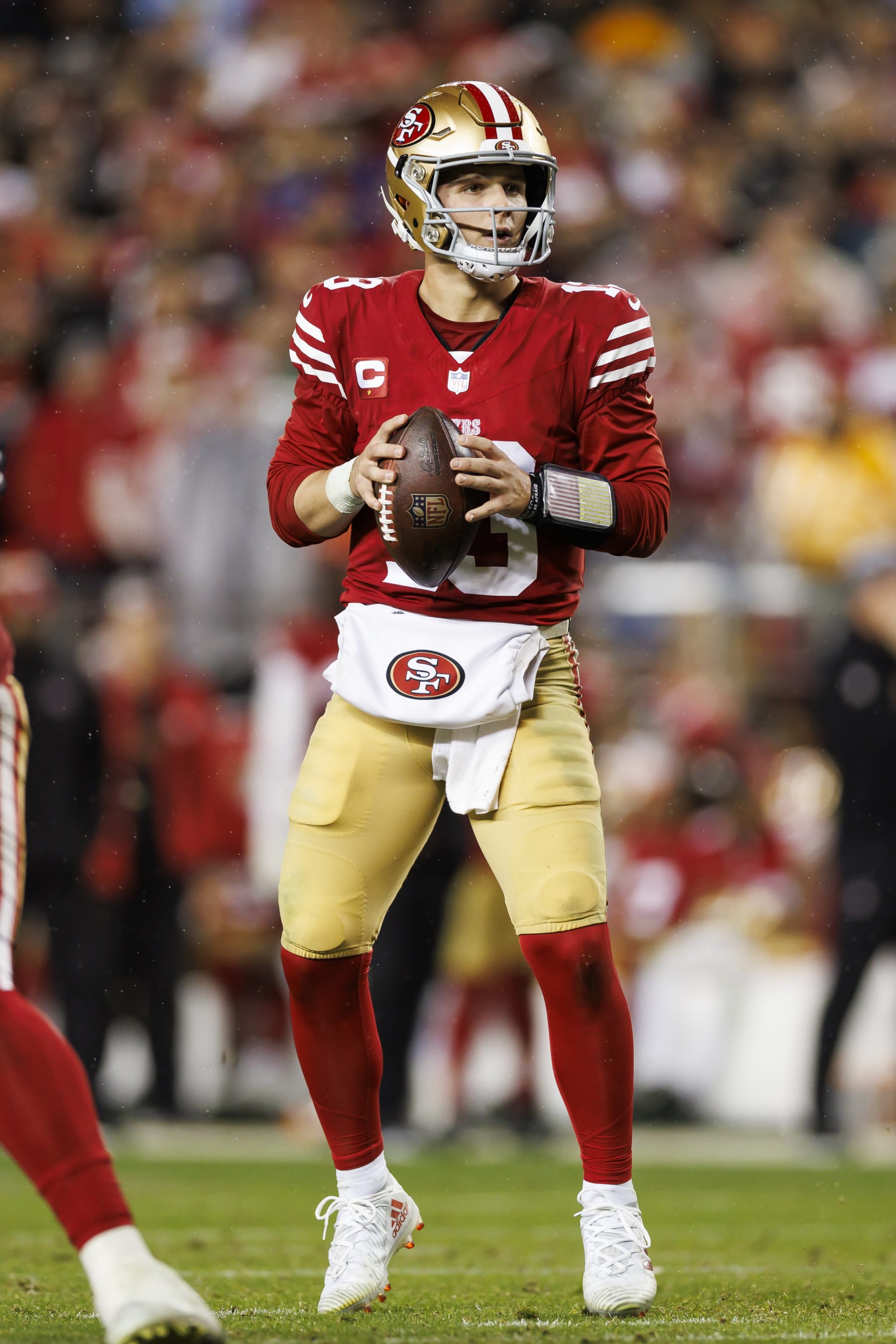 SANTA CLARA, CALIFORNIA - JANUARY 20: Brock Purdy #13 of the San Francisco 49ers drops back and looks to throw a pass during an NFC divisional round playoff football game against the Green Bay Packers at Levi's Stadium on January 20, 2024 in Santa Clara, California. (Photo by Ryan Kang/Getty Images)