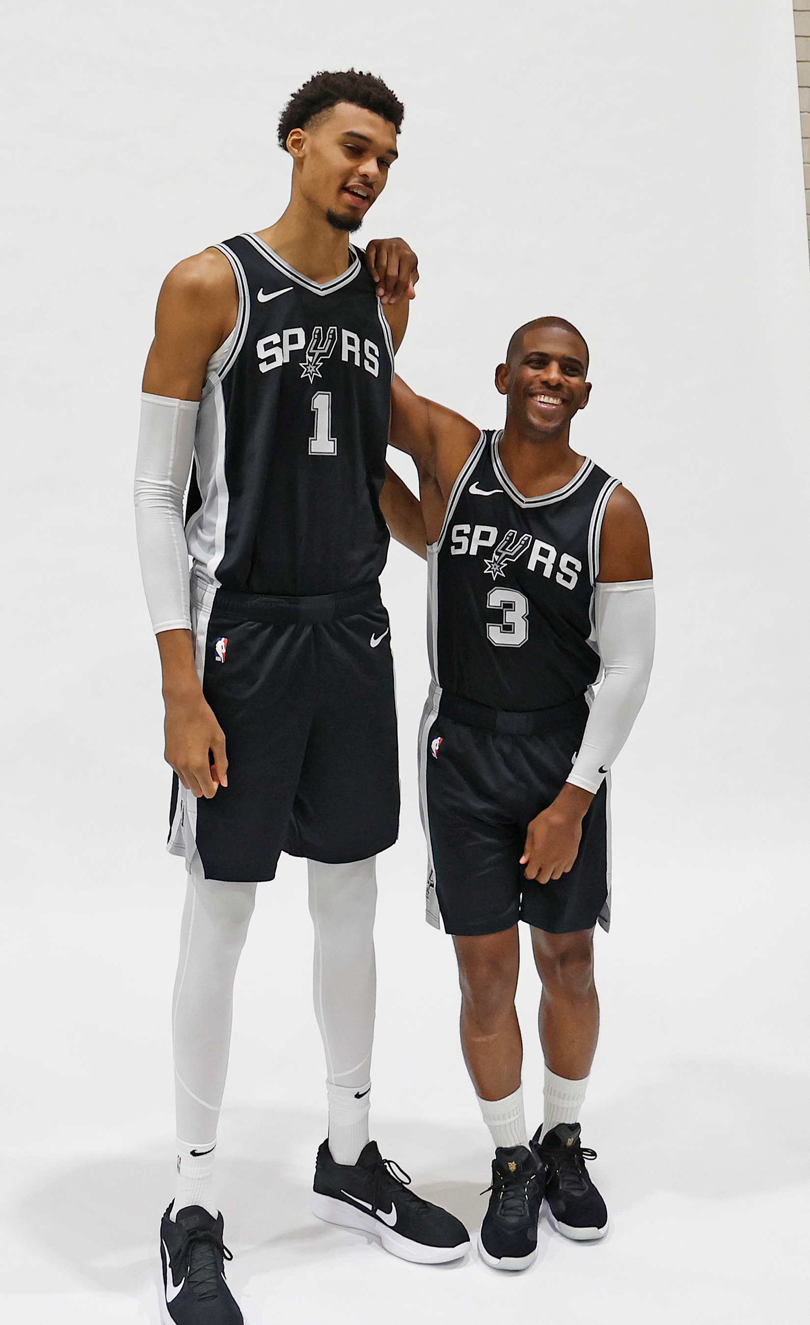 SAN ANTONIO, TX - SEPTEMBER 30: Victor Wembanyama #1 of the San Antonio Spurs and Chris Paul #3 prepare to have their photograph taken at the  San Antonio Spurs Media Day at the Victory Capital Performance Center on September 30, 2024 in San Antonio, Texas. NOTE TO USER: User expressly acknowledges and agrees that, by downloading and or using this photograph, User is consenting to terms and conditions of the Getty Images License Agreement. (Photo by Ronald Cortes/Getty Images)