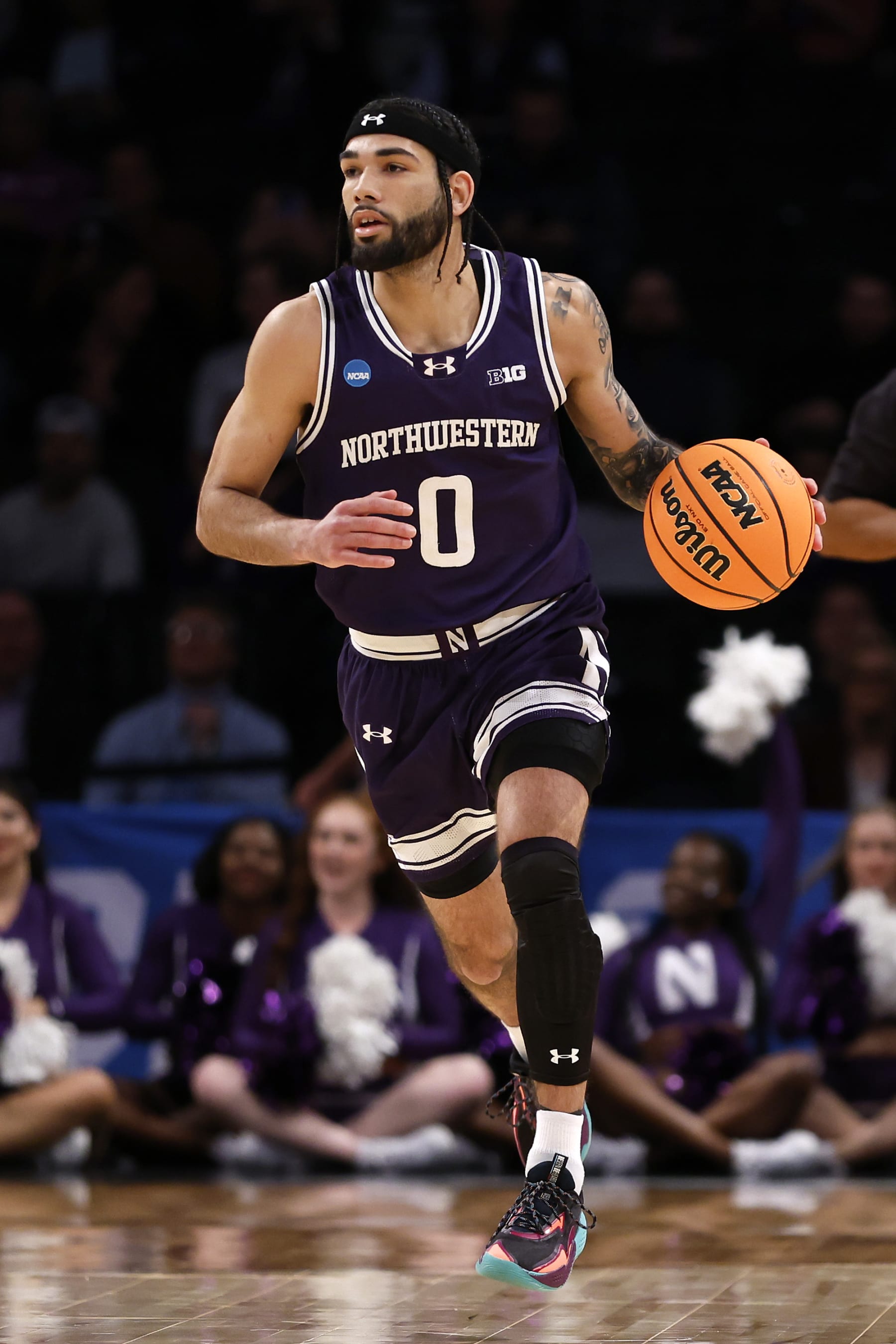 NEW YORK, NEW YORK - MARCH 22: Boo Buie #0 of the Northwestern Wildcats brings the ball up court in the first half against the Florida Atlantic Owls in the first round of the NCAA Men's Basketball Tournament at Barclays Center on March 22, 2024 in New York City. (Photo by Sarah Stier/Getty Images)