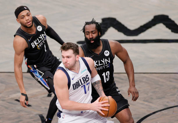 NEW YORK, NEW YORK - FEBRUARY 27: Luka Doncic #77 of the Dallas Mavericks looks to pass as Bruce Brown #1 and James Harden #13 of the Brooklyn Nets defend during the first half at Barclays Center on February 27, 2021 in the Brooklyn borough of New York City. NOTE TO USER: User expressly acknowledges and agrees that, by downloading and or using this Photograph, user is consenting to the terms and conditions of the Getty Images License Agreement. (Photo by Sarah Stier/Getty Images)