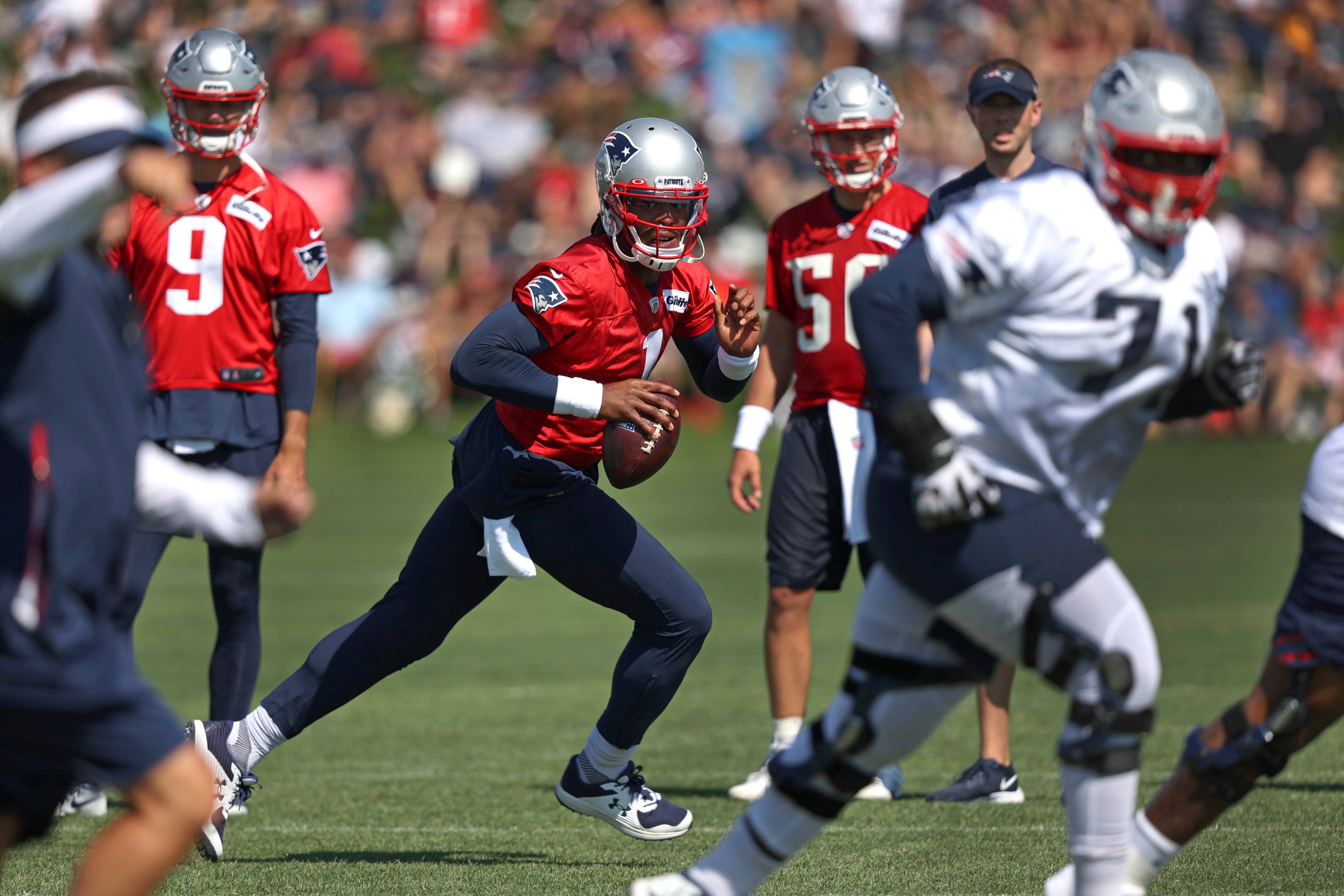 Foxborough, MA - July 31: New England Patriots quarterback Cam Newton (1) rolls out of the pocket during team drills on Day 4 of Patriots training camp in Foxborough, MA on July 31, 2021. (Photo by Barry Chin/The Boston Globe via Getty Images)
