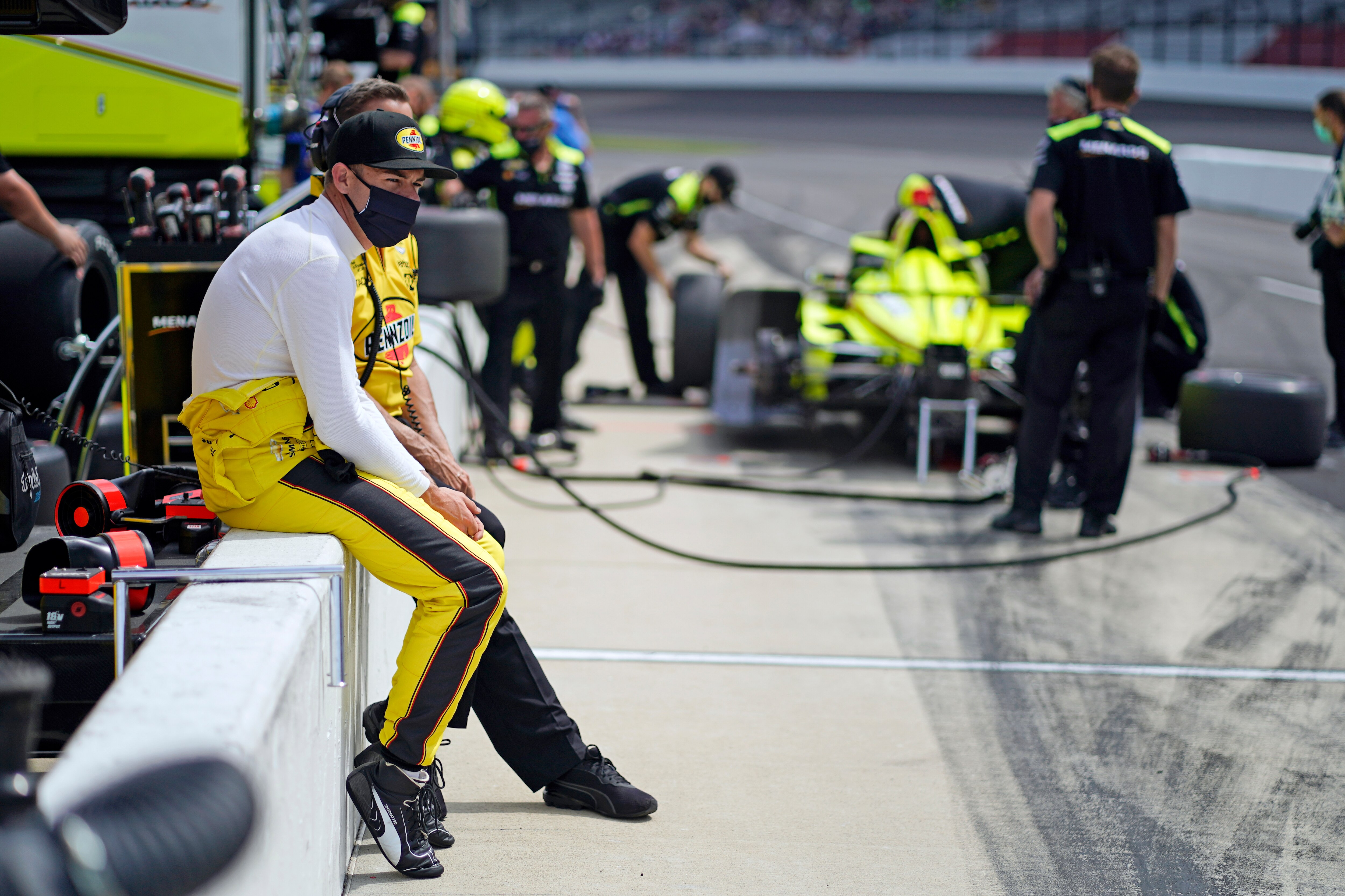 Scott McLaughlin, of New Zealand, watches as he sits on pit wall during practice for the Indianapolis 500 auto race at Indianapolis Motor Speedway, Thursday, May 20, 2021, in Indianapolis. (AP Photo/Darron Cummings)