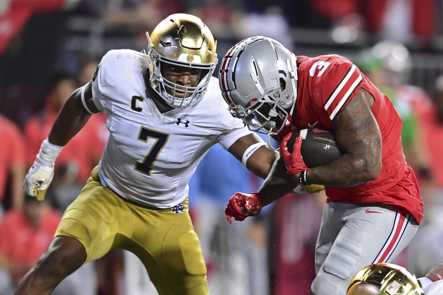 Ohio State running back Miyan Williams runs before being hit by Notre Dame defensive lineman Isaiah Foskey during the fourth quarter of an NCAA college football game, Saturday, Sept. 3, 2022, in Columbus, Ohio. Ohio State won 21-10. (AP Photo/David Dermer)