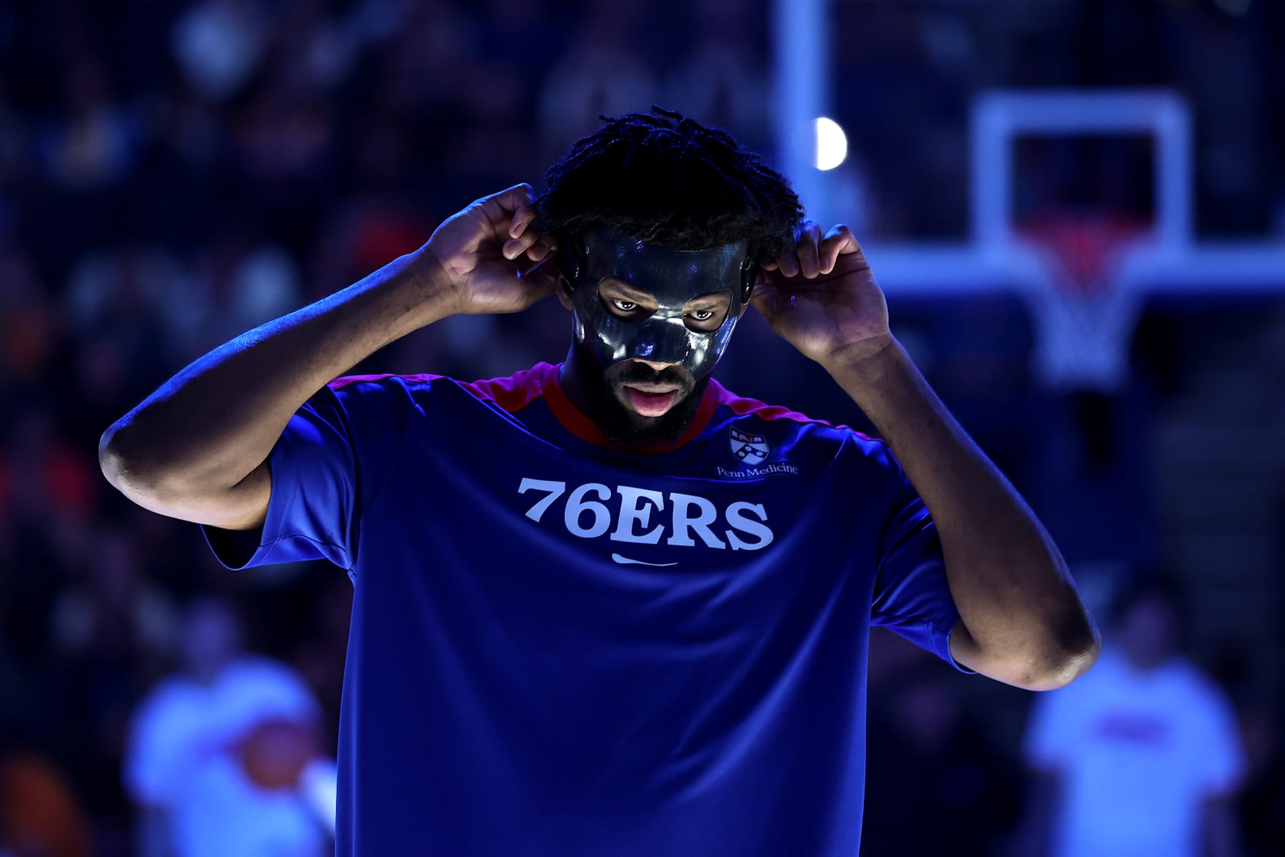 SAN FRANCISCO, CALIFORNIA - JANUARY 02: Joel Embiid #21 of the Philadelphia 76ers puts on his face protection mask before their game against the Golden State Warriors at Chase Center on January 02, 2025 in San Francisco, California. NOTE TO USER: User expressly acknowledges and agrees that, by downloading and/or using this photograph, user is consenting to the terms and conditions of the Getty Images License Agreement.   (Photo by Ezra Shaw/Getty Images)