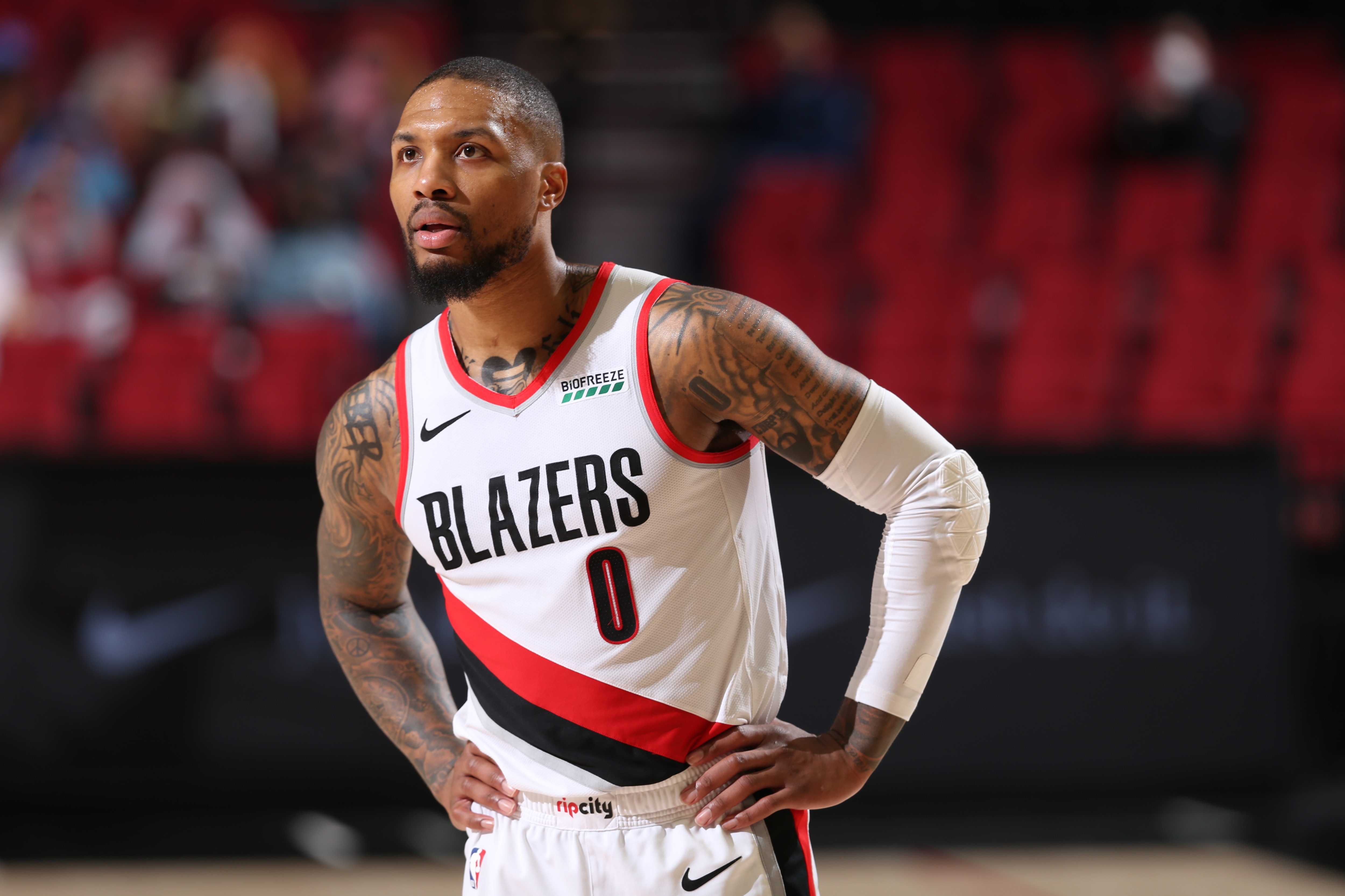PORTLAND, OR - APRIL 25: Damian Lillard #0 of the Portland Trail Blazers looks on during the game against the Memphis Grizzlies on April 25, 2021 at the Moda Center Arena in Portland, Oregon. NOTE TO USER: User expressly acknowledges and agrees that, by downloading and or using this photograph, user is consenting to the terms and conditions of the Getty Images License Agreement. Mandatory Copyright Notice: Copyright 2021 NBAE (Photo by Sam Forencich/NBAE via Getty Images)