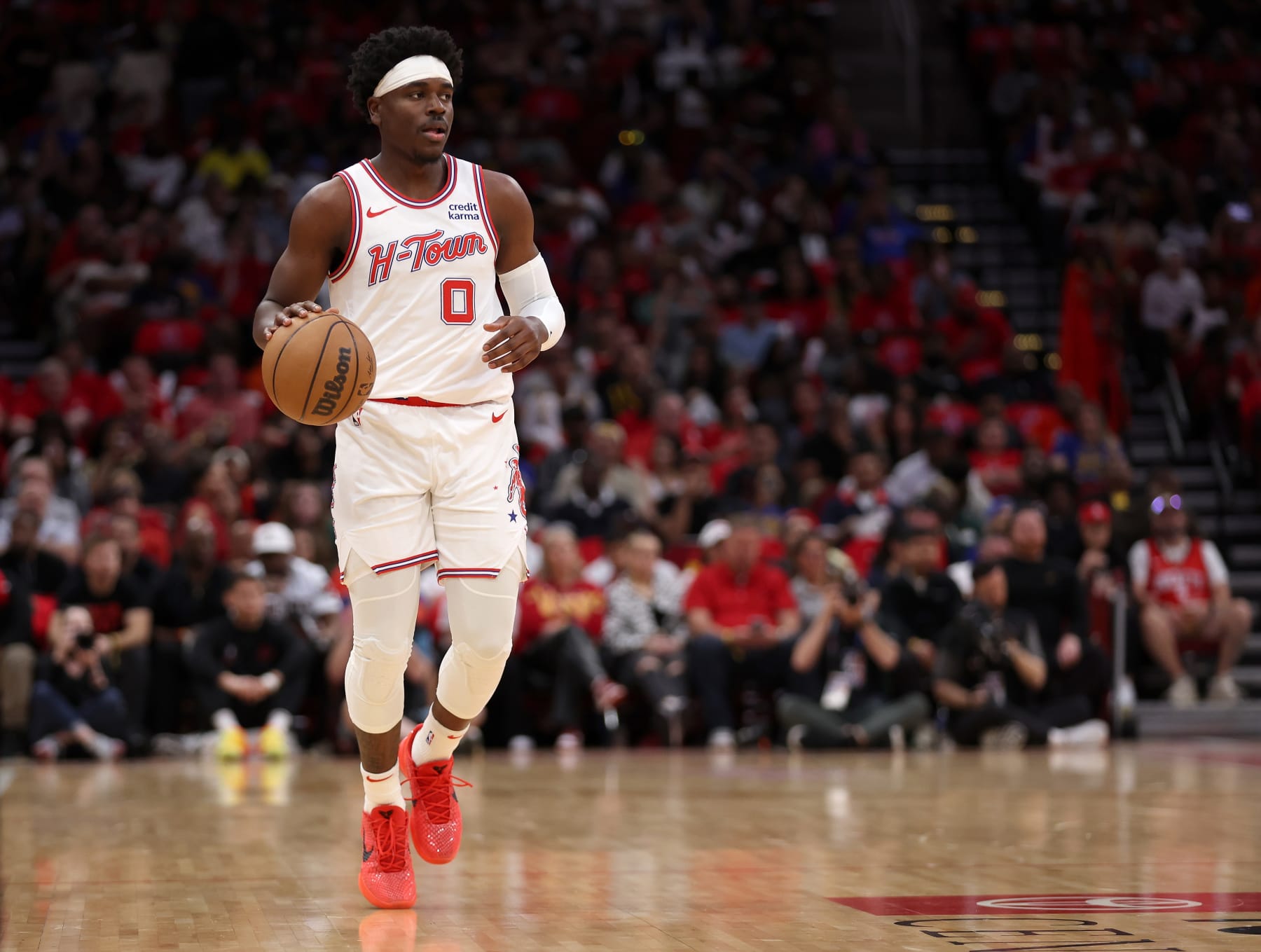 HOUSTON, TEXAS - APRIL 04: Aaron Holiday #0 of the Houston Rockets brings the ball up court in the second half against the Golden State Warriors at Toyota Center on April 04, 2024 in Houston, Texas.  NOTE TO USER: User expressly acknowledges and agrees that, by downloading and or using this photograph, User is consenting to the terms and conditions of the Getty Images License Agreement. (Photo by Tim Warner/Getty Images)
