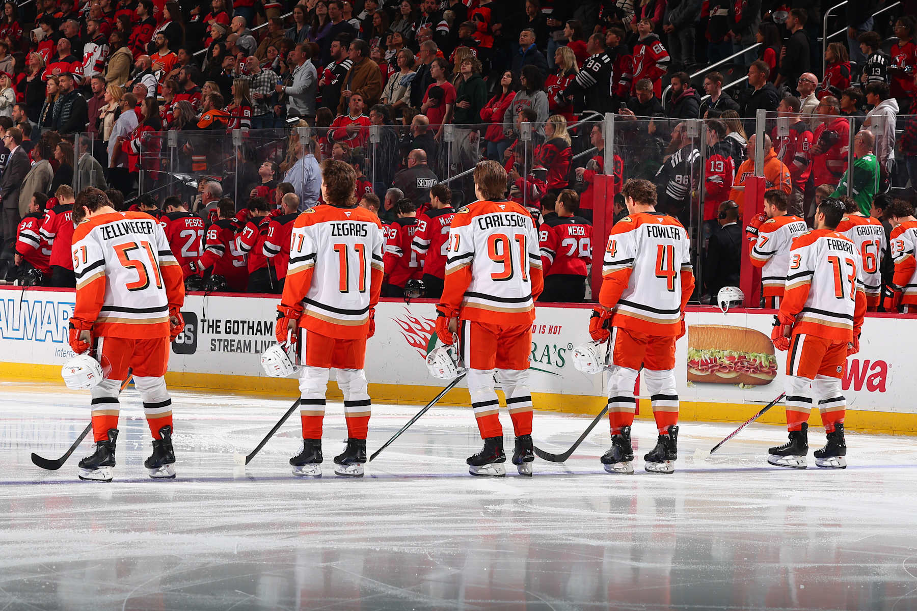 NEWARK, NJ - OCTOBER 27:  Olen Zellweger #51 of the Anaheim Ducks, Trevor Zegras #11, Leo Carlsson #91, Cam Fowler #4 and Robby Fabbri #13 of the Anaheim Ducks during the National Anthem prior to  the game against the New Jersey Devils at the Prudential Center on October 27, 2024 in Newark, New Jersey.  (Photo by Tori Graessle/NHLI via Getty Images)