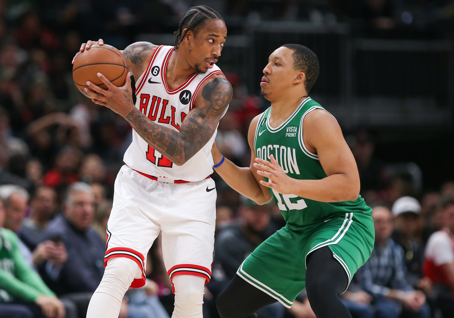 CHICAGO, IL - NOVEMBER 21: Boston Celtics forward Grant Williams (12) posts up against Chicago Bulls forward DeMar DeRozan (11) during a NBA game between the Boston Celtics and the Chicago Bulls on November 21, 2022 at the United Center in Chicago, IL. (Photo by Melissa Tamez/Icon Sportswire via Getty Images)