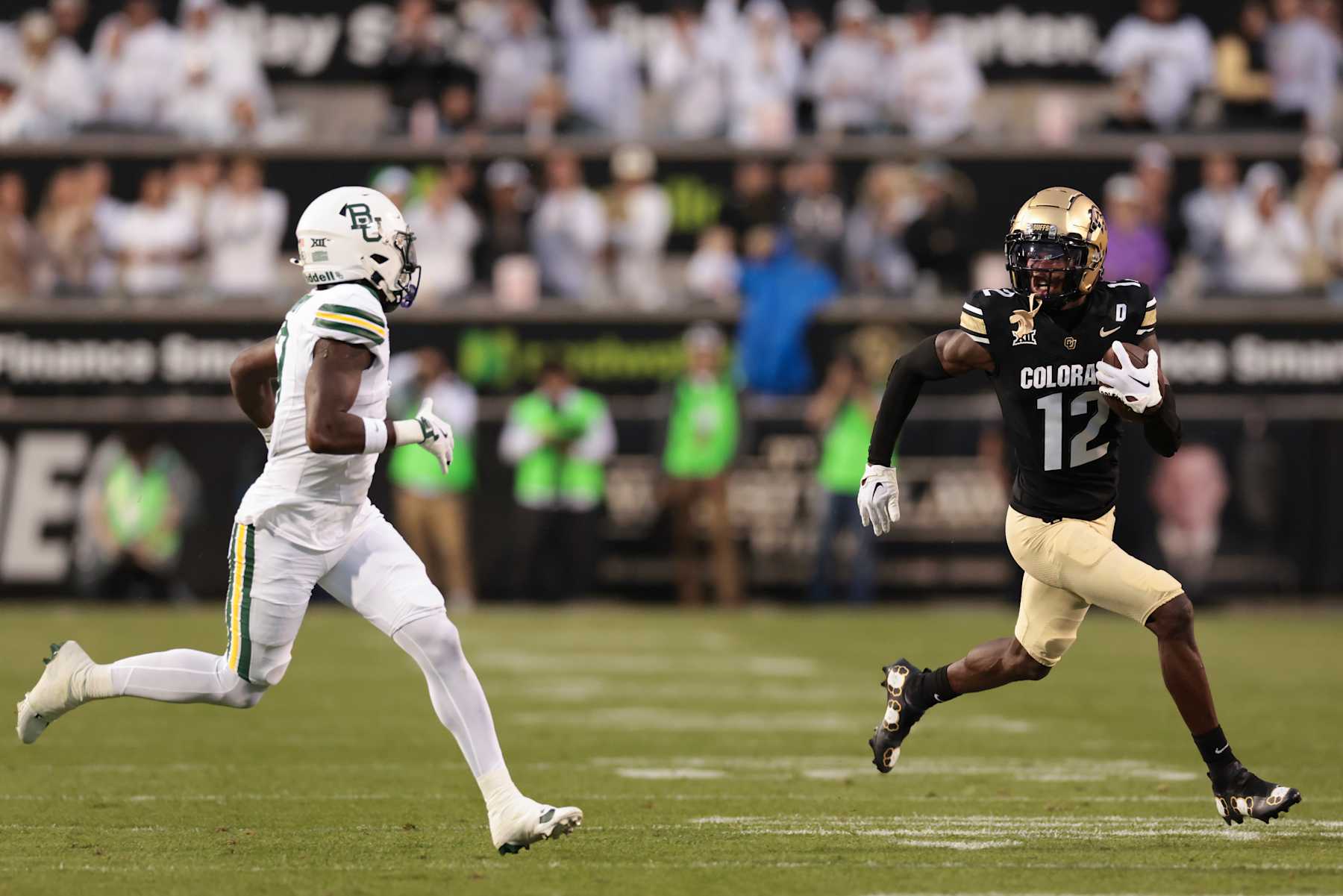 BOULDER, COLORADO - SEPTEMBER 21: Travis Hunter #12 of the Colorado Buffaloes runs with the ball during the first quarter against the Baylor Bears at Folsom Field on September 21, 2024 in Boulder, Colorado. (Photo by Andrew Wevers/Getty Images)