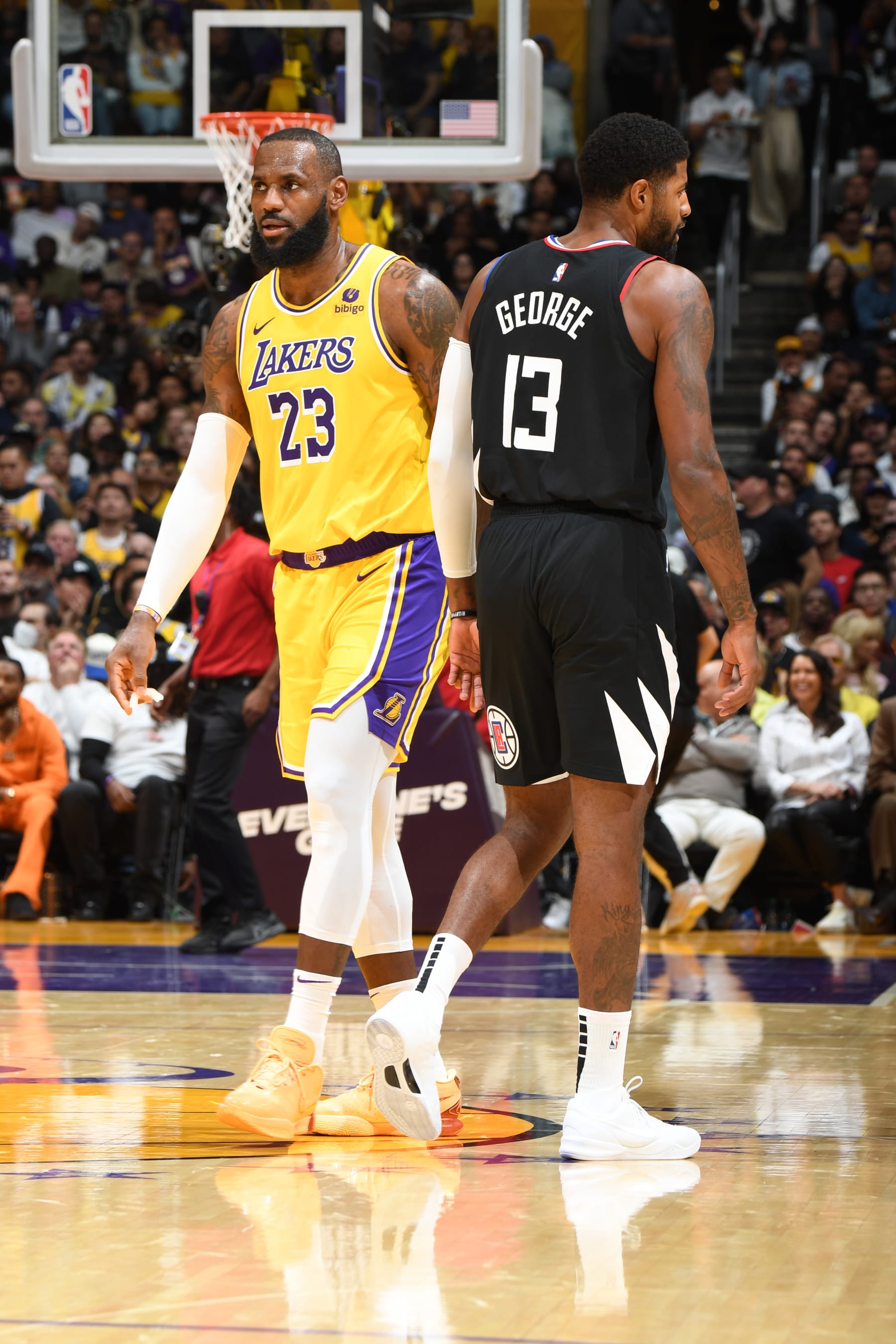 LOS ANGELES, CA - NOVEMBER 1: LeBron James #23 of the Los Angeles Lakers and Paul George #13 of the LA Clippers look on during the game on November 1, 2023 at Crypto.Com Arena in Los Angeles, California. NOTE TO USER: User expressly acknowledges and agrees that, by downloading and/or using this Photograph, user is consenting to the terms and conditions of the Getty Images License Agreement. Mandatory Copyright Notice: Copyright 2023 NBAE (Photo by Andrew D. Bernstein/NBAE via Getty Images)
