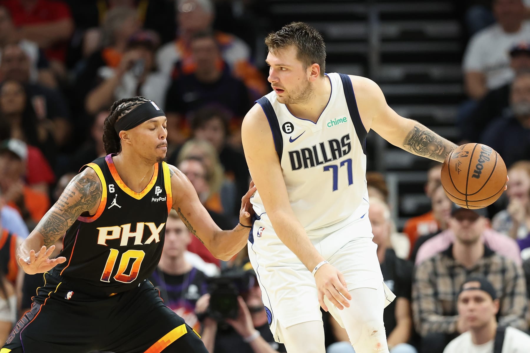PHOENIX, ARIZONA - OCTOBER 19: Luka Doncic #77 of the Dallas Mavericks handles the ball against Damion Lee #10 of the Phoenix Suns during the second half of the NBA game at Footprint Center on October 19, 2022 in Phoenix, Arizona. The Suns defeated the Mavericks 107-105. NOTE TO USER: User expressly acknowledges and agrees that, by downloading and or using this photograph, User is consenting to the terms and conditions of the Getty Images License Agreement.  (Photo by Christian Petersen/Getty Images)
