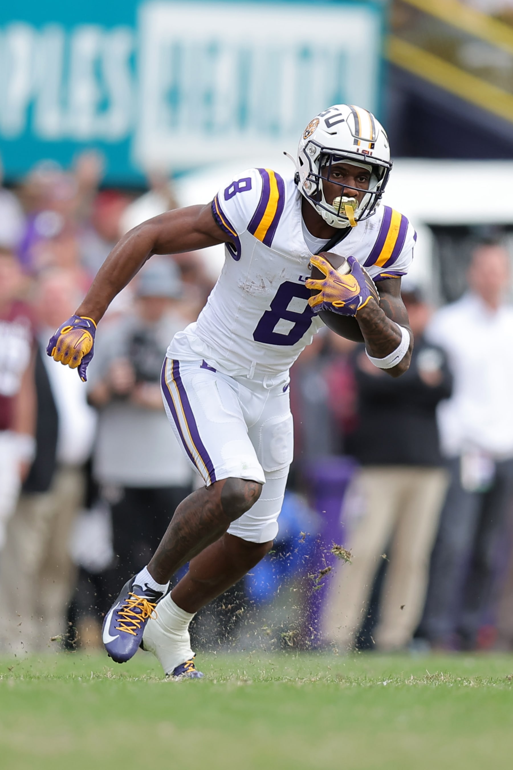 BATON ROUGE, LOUISIANA - NOVEMBER 25: Malik Nabers #8 of the LSU Tigers runs with the ball against the Texas A&M Aggies during a game at Tiger Stadium on November 25, 2023 in Baton Rouge, Louisiana. (Photo by Jonathan Bachman/Getty Images)