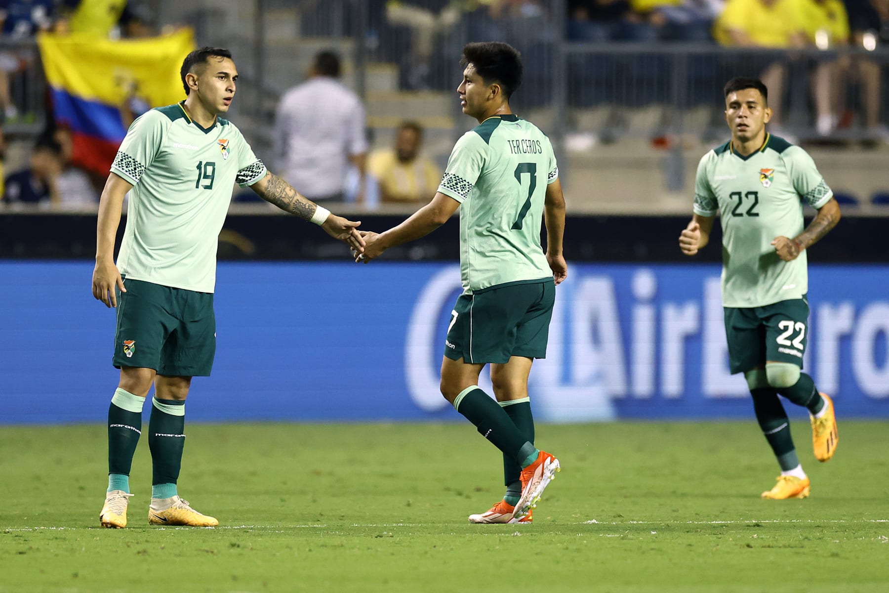 CHESTER, PENNSYLVANIA - JUNE 12: Bruno Miranda #19 and Miguel Terceros #7 of Bolivia react following a goal scored by Terceros during the second half against Ecuador at Subaru Park on June 12, 2024 in Chester, Pennsylvania. (Photo by Tim Nwachukwu/Getty Images)