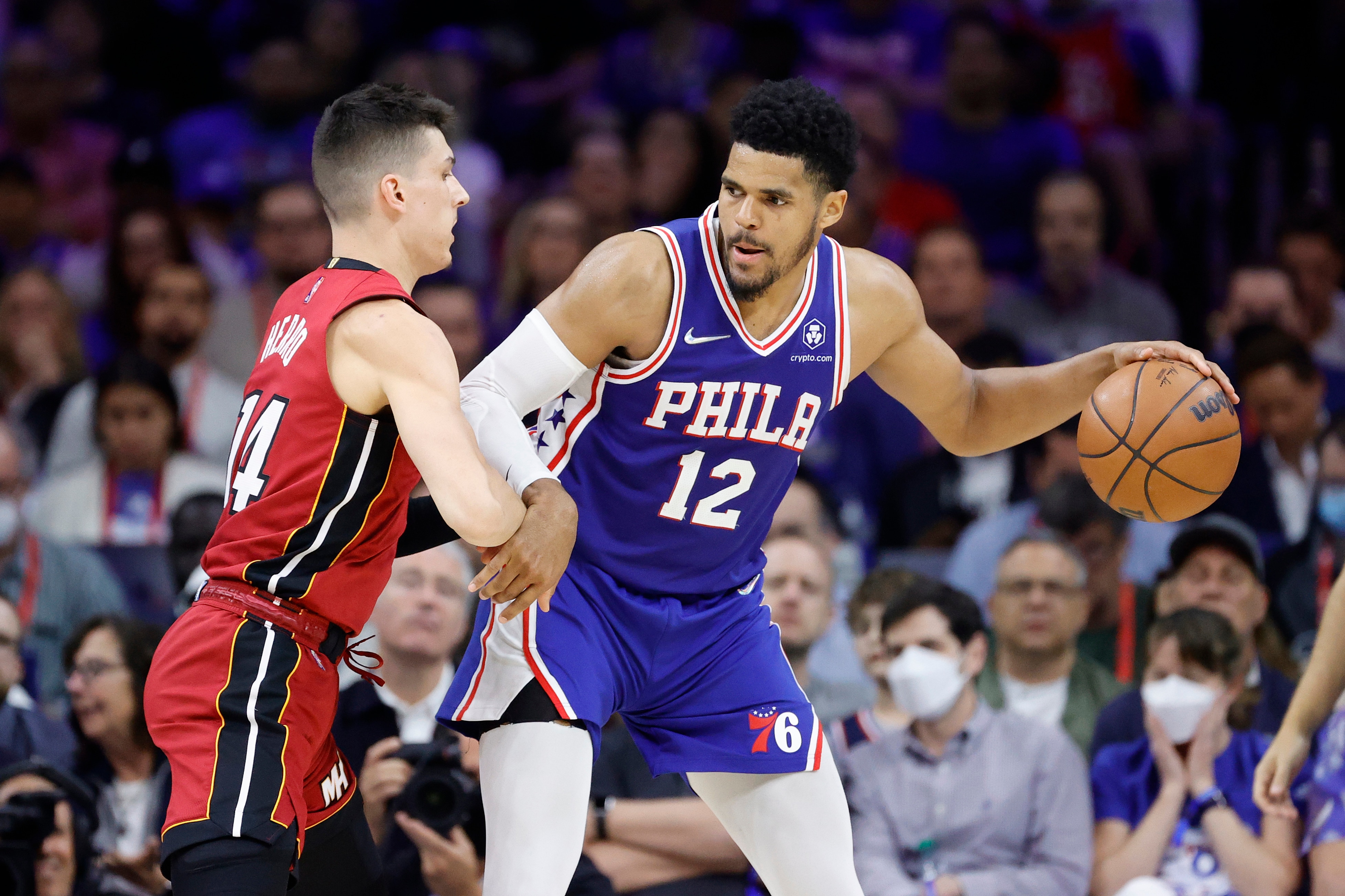 PHILADELPHIA, PENNSYLVANIA - MAY 12: Tobias Harris #12 of the Philadelphia 76ers handles the ball against Tyler Herro #14 of the Miami Heat during the second half in Game Six of the 2022 NBA Playoffs Eastern Conference Semifinals at Wells Fargo Center on May 12, 2022 in Philadelphia, Pennsylvania. NOTE TO USER: User expressly acknowledges and agrees that, by downloading and/or using this photograph, User is consenting to the terms and conditions of the Getty Images License Agreement. (Photo by Tim Nwachukwu/Getty Images)