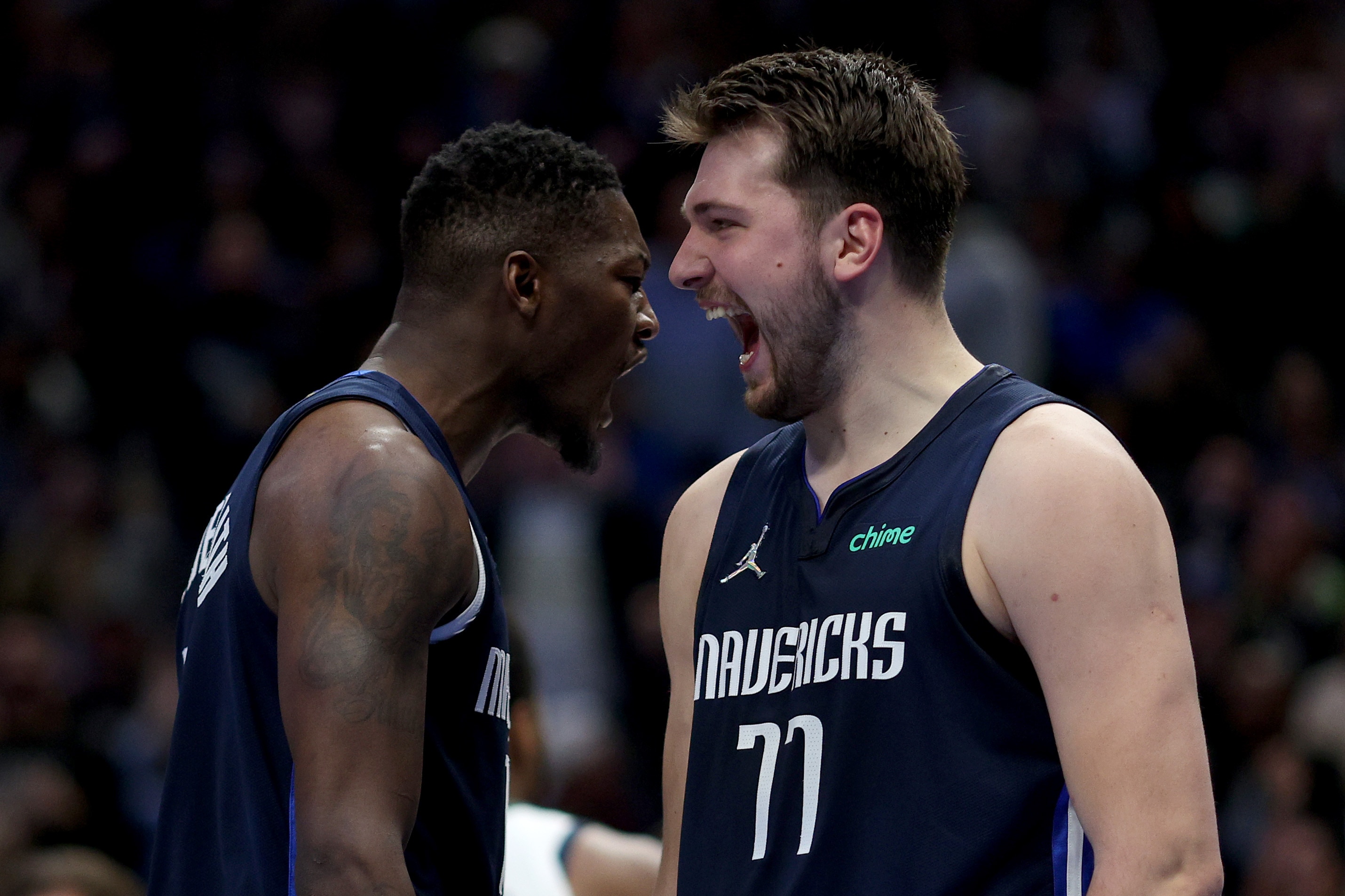 DALLAS, TEXAS - MARCH 07: Dorian Finney-Smith #10 of the Dallas Mavericks celebrates with Luka Doncic #77 of the Dallas Mavericks after scoring against the Utah Jazz in the first half at American Airlines Center on March 07, 2022 in Dallas, Texas. NOTE TO USER: User expressly acknowledges and agrees that, by downloading and or using this photograph, User is consenting to the terms and conditions of the Getty Images License Agreement. (Photo by Tom Pennington/Getty Images)